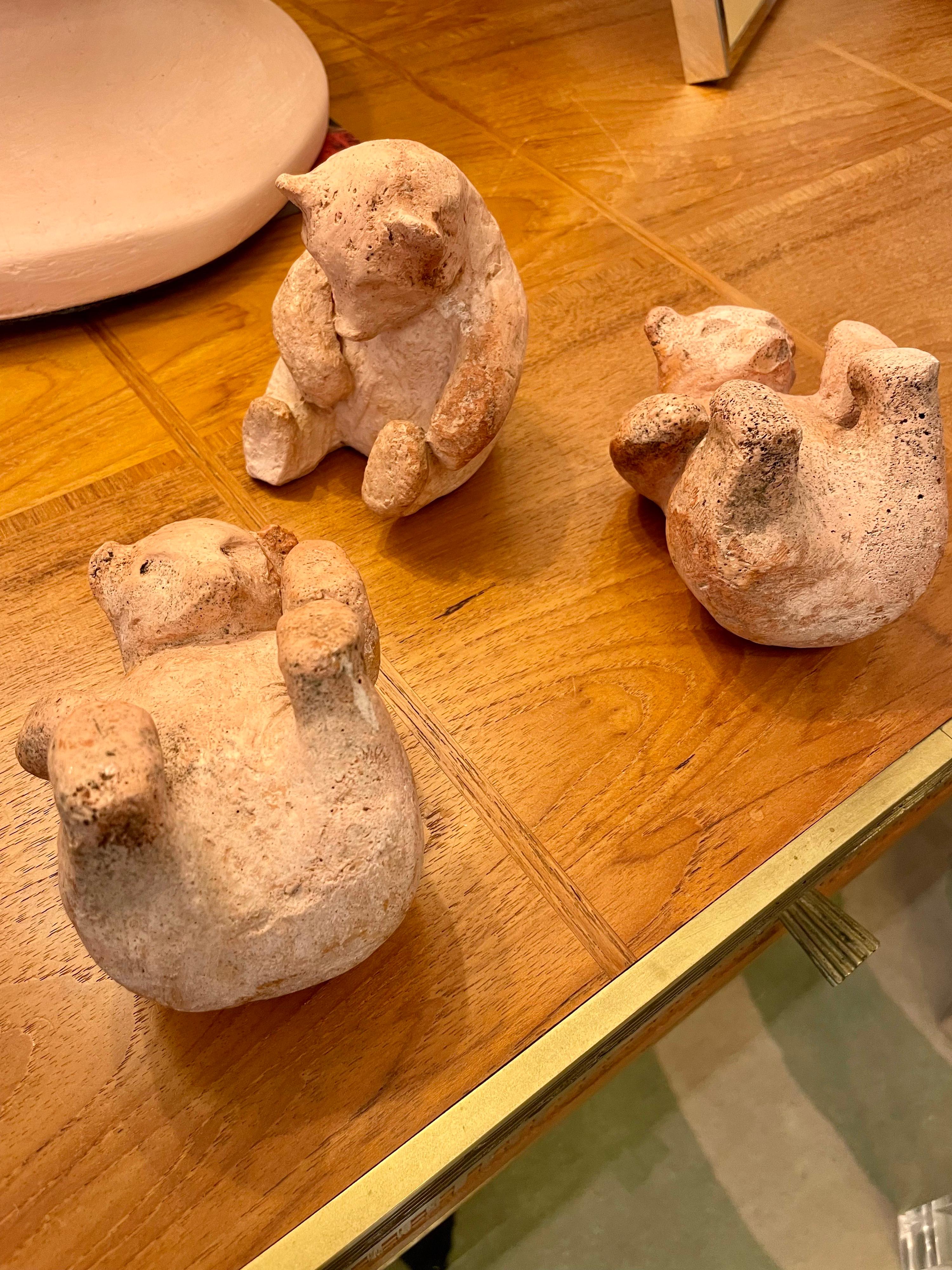 Soft rose patina to this earthenware small sculptures/ paper weights depicting a family of playful bear cubs. One is marked to underside with initials 