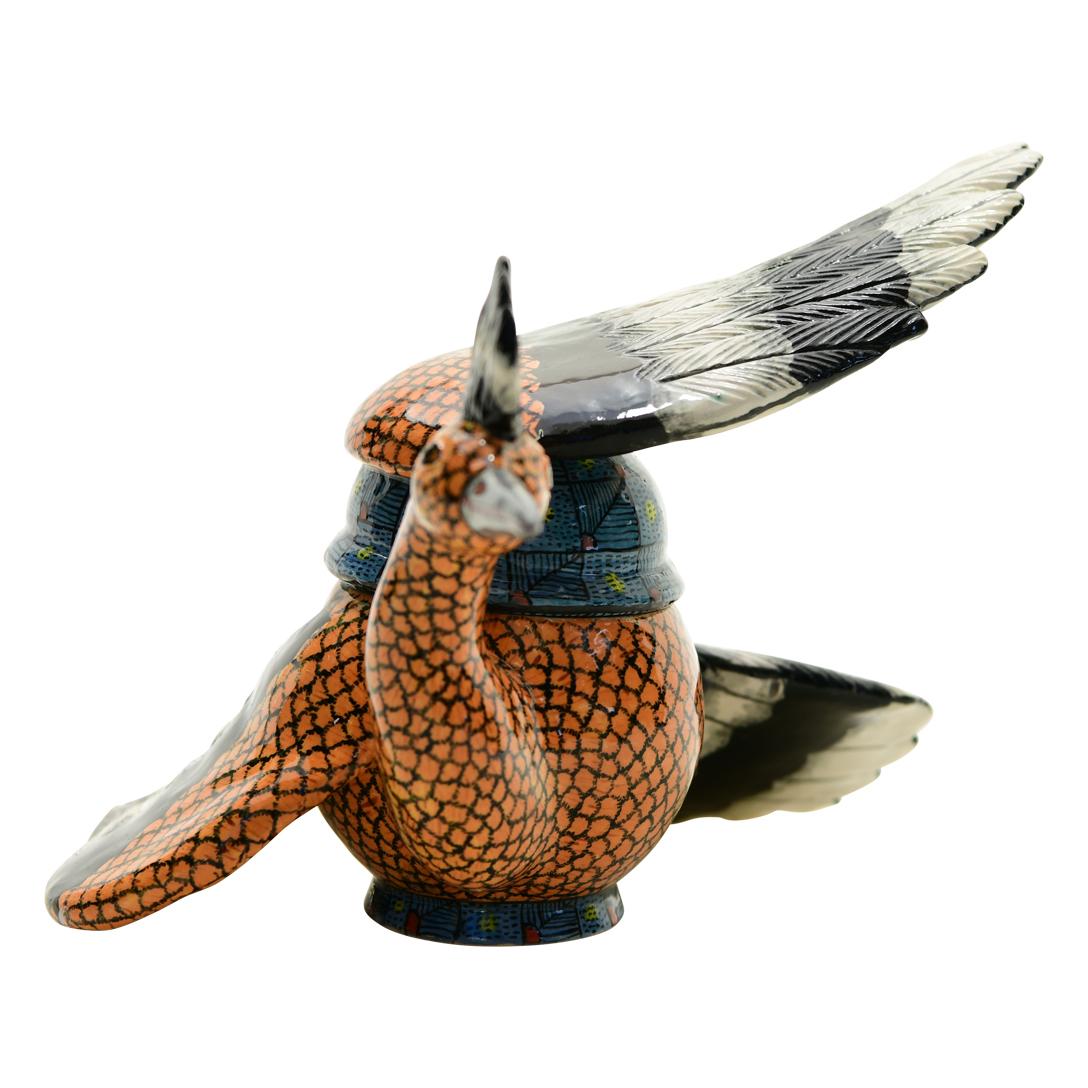 This Hoopoe Box was hand sculpted by the renowned artisan Sbusiso Ndaba and beautifully painted by Ntokozo Nene both from South Africa. This exquisite ceramic creation stands 5 inches high, measuring 7 inches in length and 7 inches in width.
 A