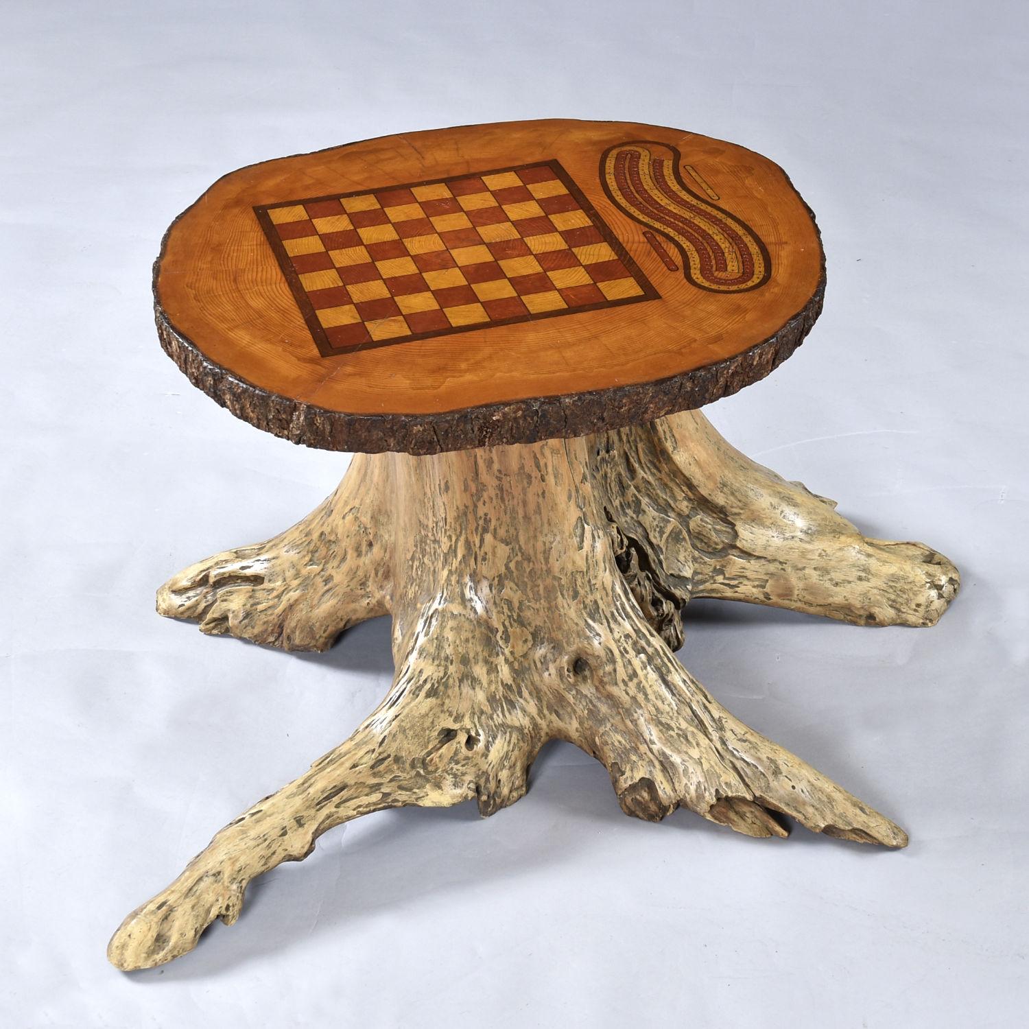 Hand made live edge chess and cribbage gaming table on a finished tree stump. This incredible work of art comes complete with a little treasure chest to house the gaming pieces. Thirty-two hand carved stone chess pieces and a group of wood cribbage