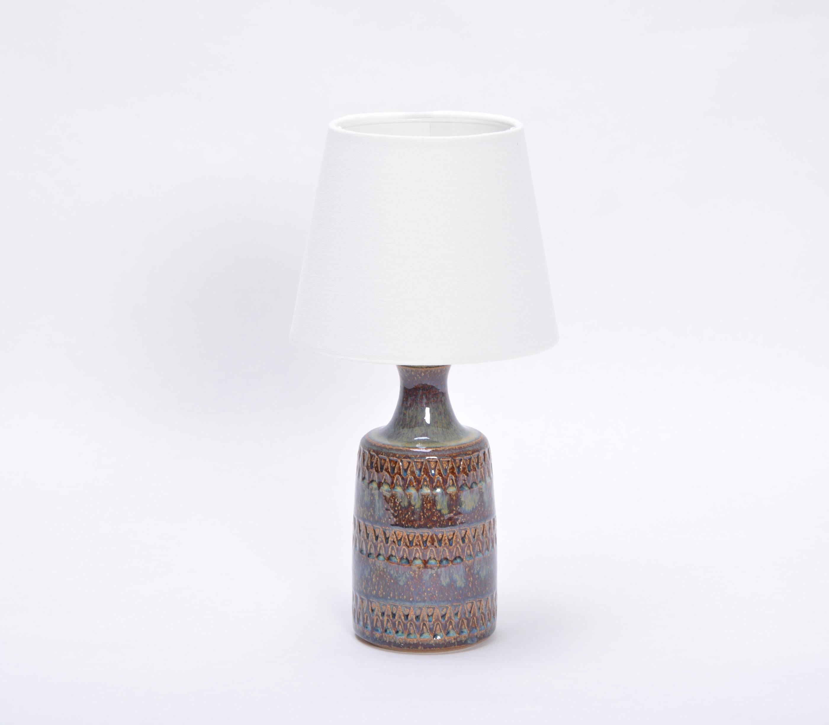 Hand made Danish mid-century ceramic table lamp model 3034 by Soholm Stentoj
Handmade and hand decorated Danish modern stoneware table lamp manufactured by Søholm Stentøj on the Danish island of Bornholm in the 1960s. Light blue glaze flows down