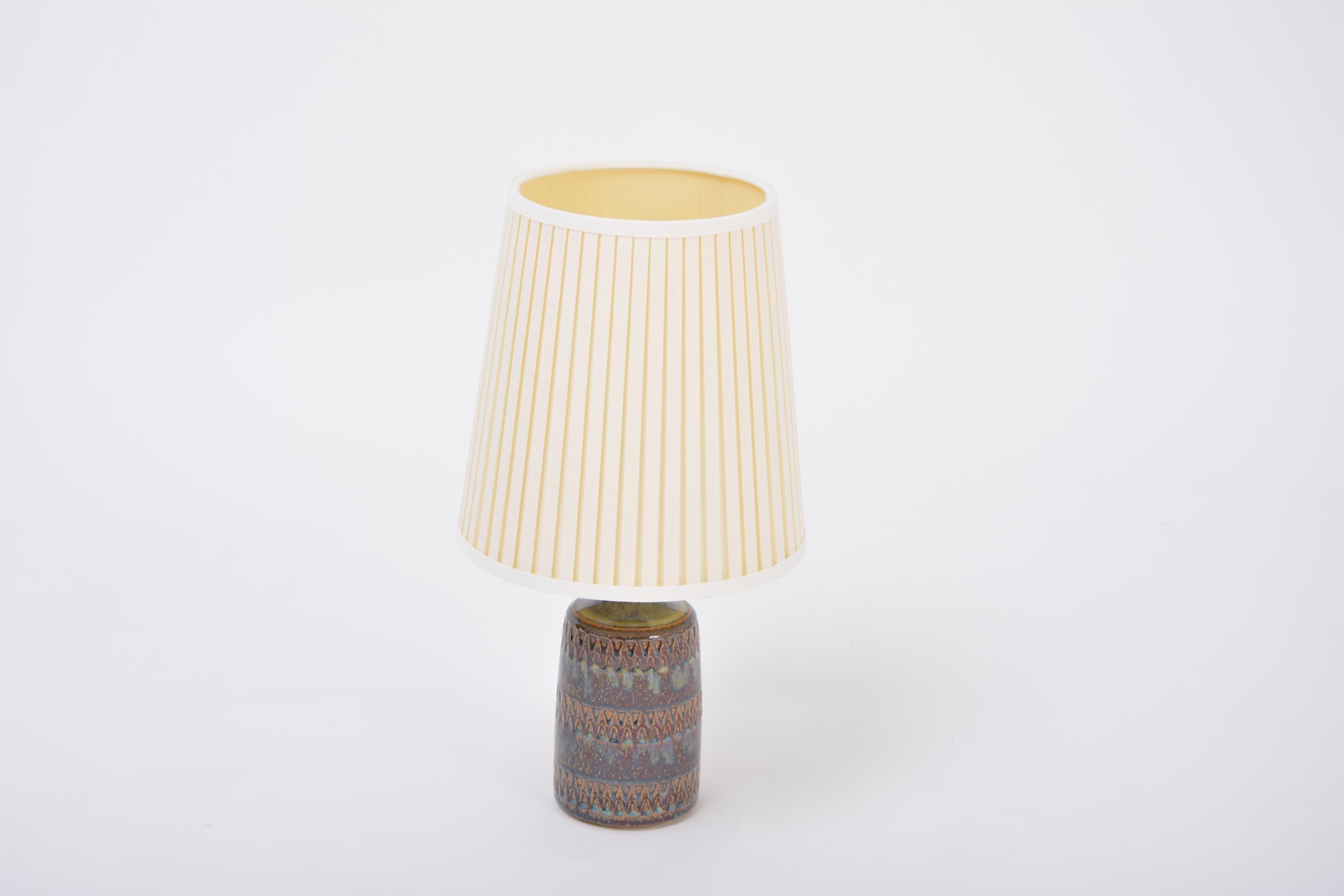 Hand Made Danish Mid-Century ceramic table lamp model 3084 by Soholm Stentoj
Handmade and hand decorated Danish modern stoneware table lamp manufactured by Søholm Stentøj on the Danish island of Bornholm in the 1960s. Light blue glaze flows down