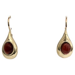 Hand made gold earrings with cabochon garnet
