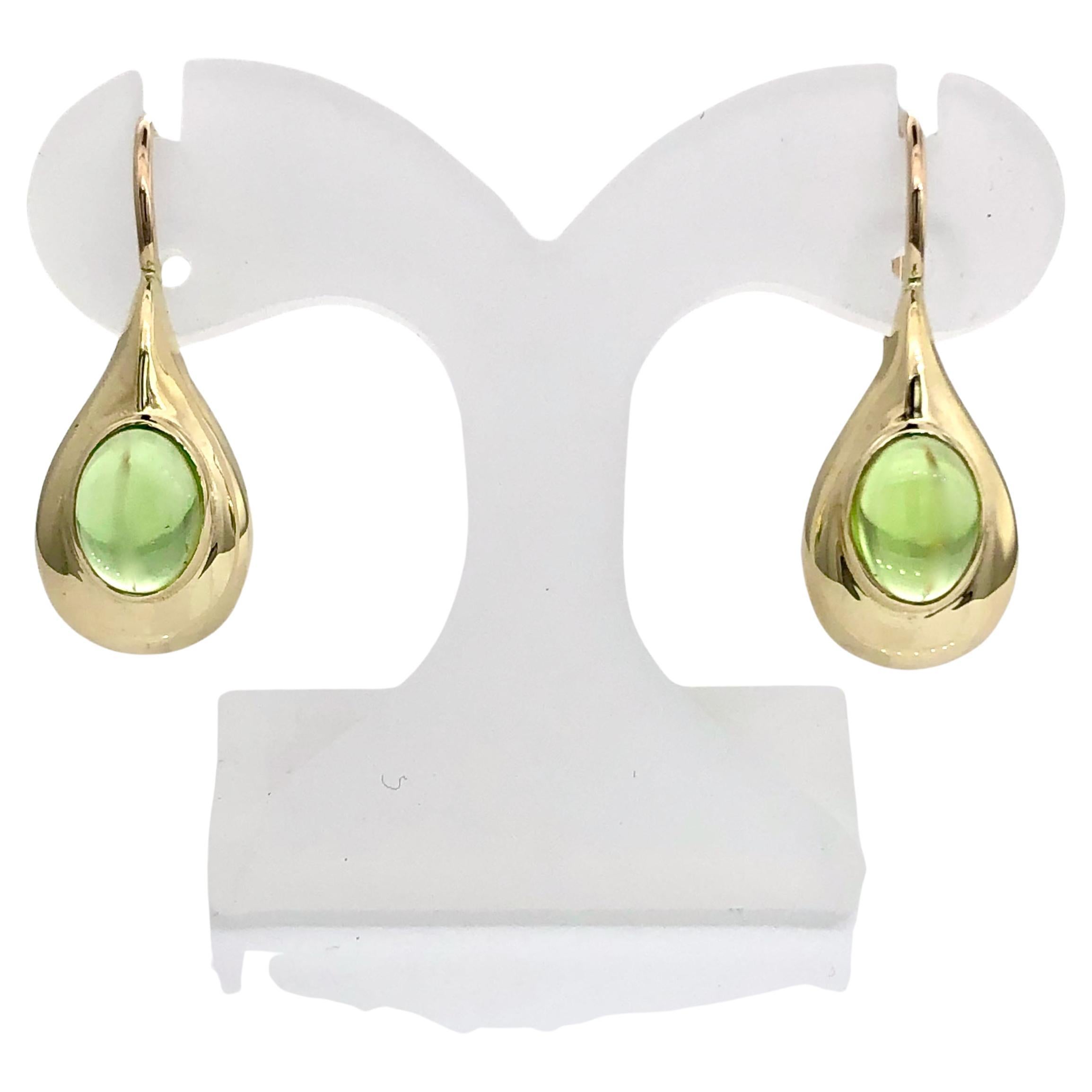 Hand made gold earrings with cabochon peridot