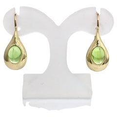 Orecchini in oro realizzati a mano con peridoto cabochon