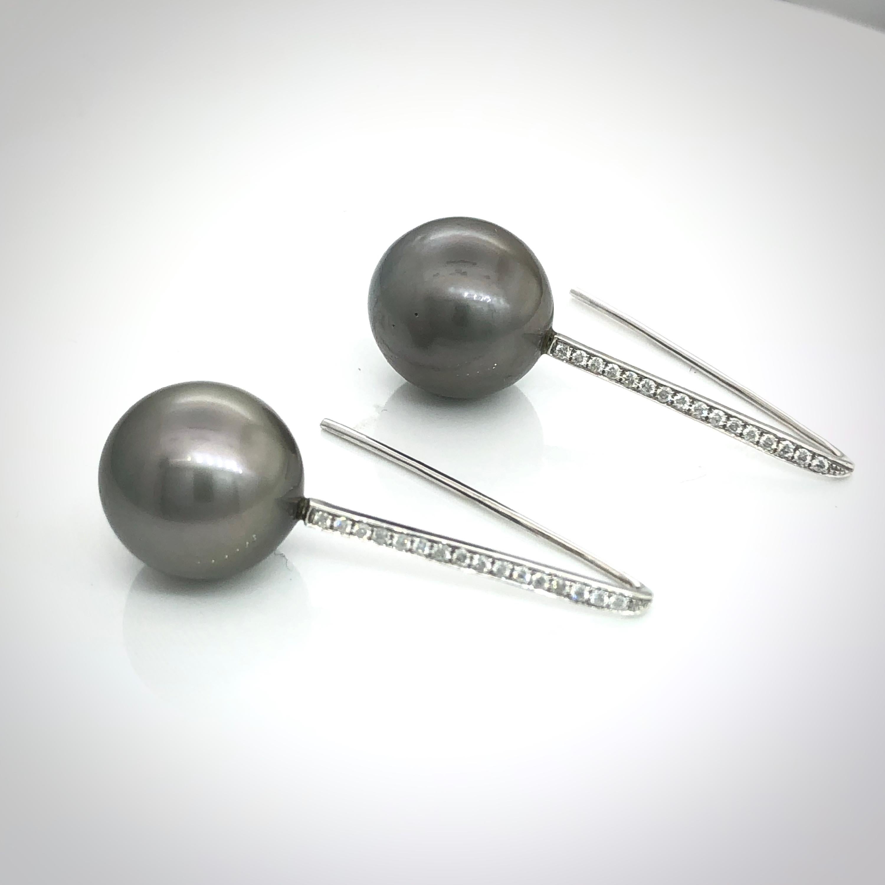 Hand made hanging  earrings in 18 carat white gold with long strait hook
Pave set with 32 brilliant cut round diamonds, totalling 0.2 carats
Round Tahitian pearls 13 mm in diameter
Weight of the earrings is 7.3 grams
Drop lenghts is 35 mm
