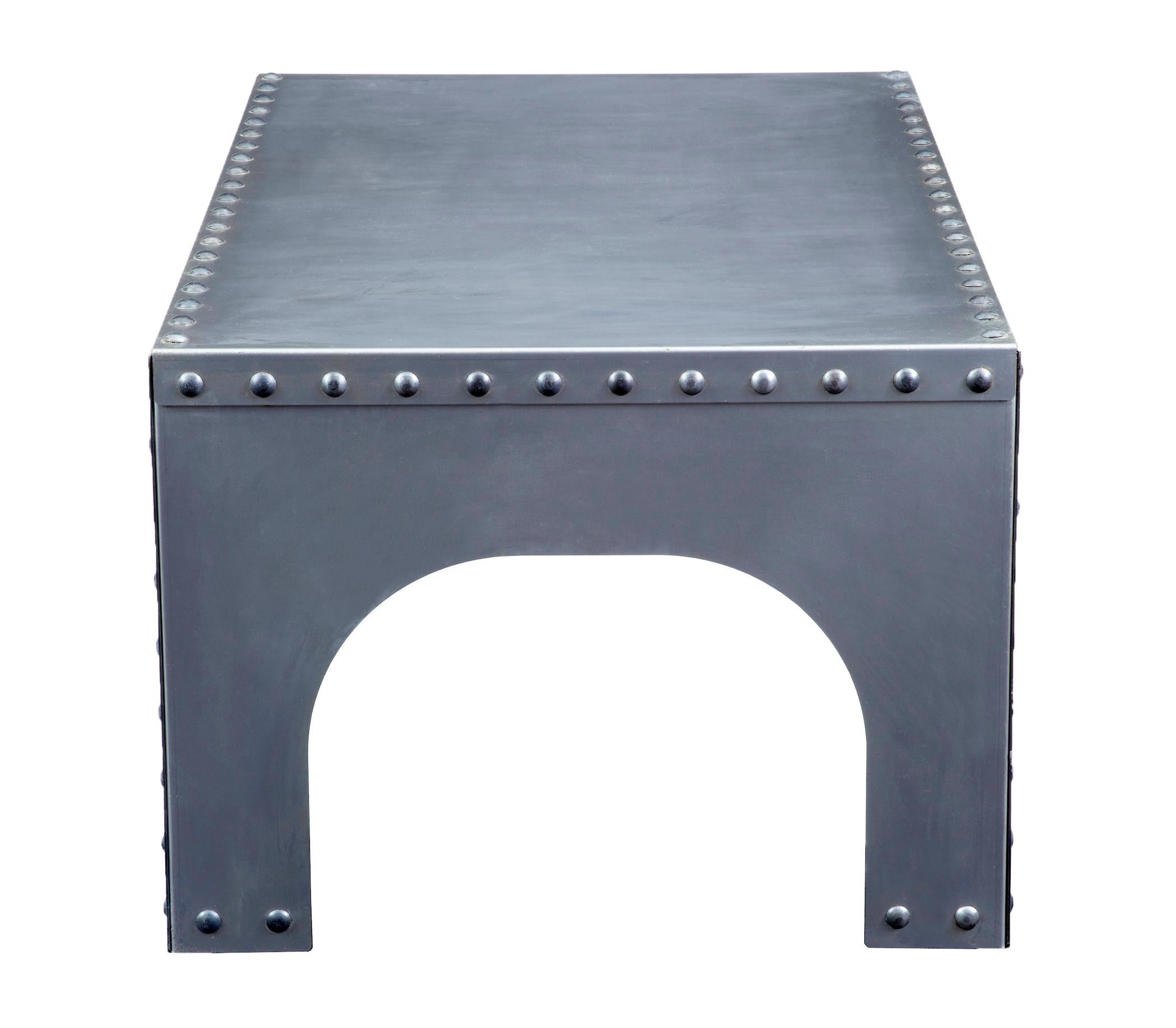 Handmade Industrial steel occasional table, circa 2000

Modern Industrial feel table, handmade and held in place by decorative rivets. Ideal for use as a side table or in the garden room

Minor surface marks.