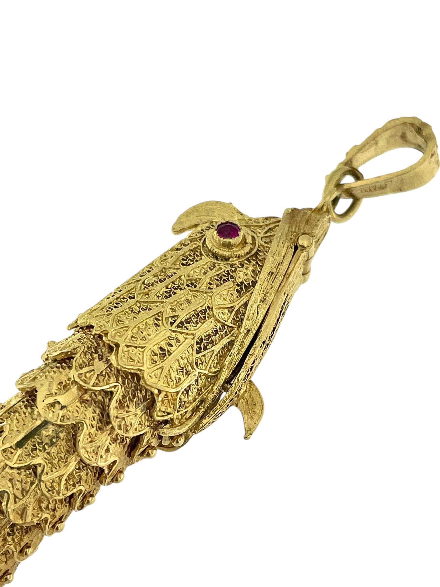 This Hand-Made Italian Yellow Gold Fish Pendant is a breathtaking showcase of exceptional craftsmanship and artistry, meticulously crafted in radiant yellow gold. The design captures the lifelike form of a fish, with a mechanism inside that allows