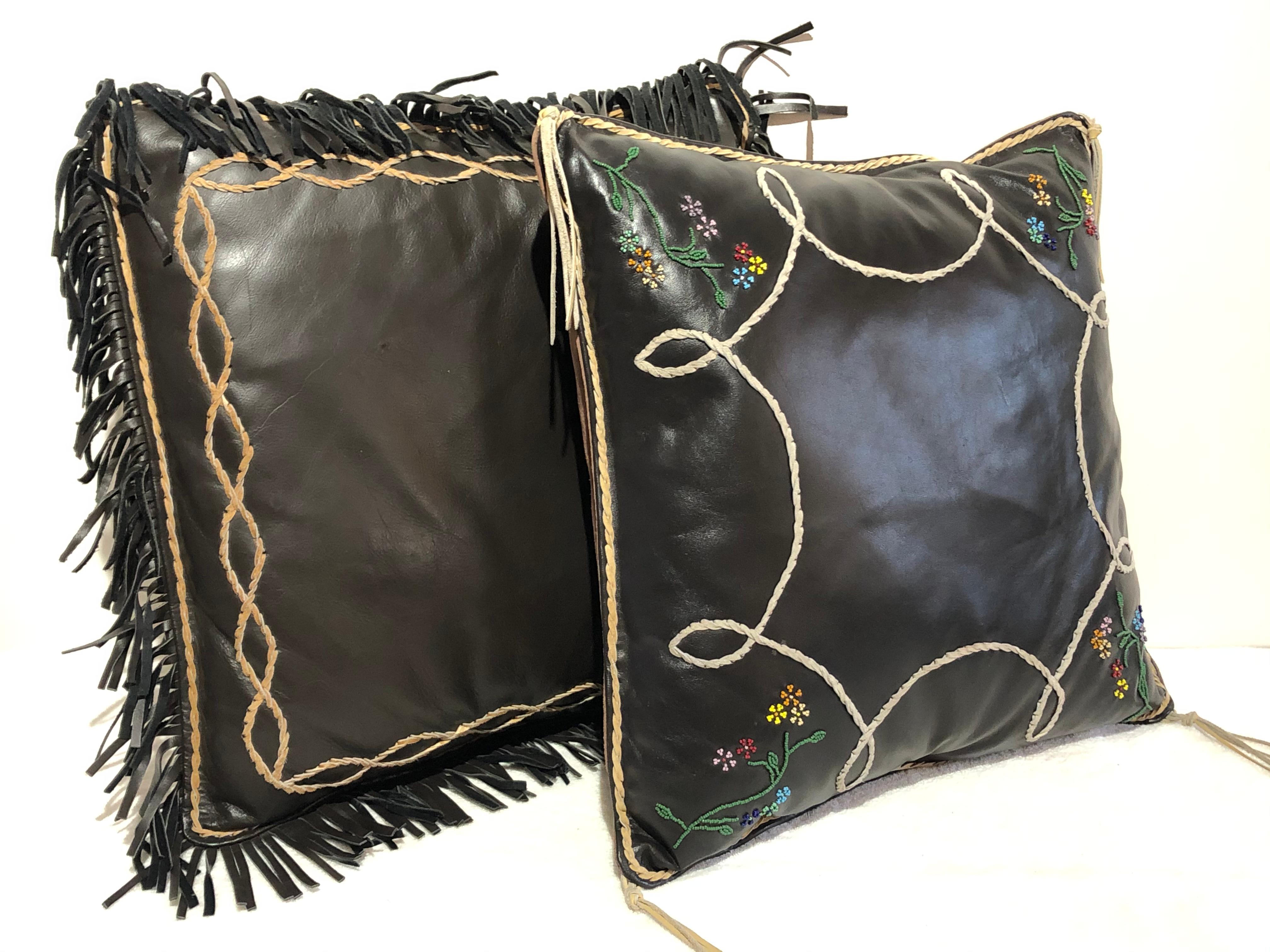 Two large leather handmade pillows, signed on the back label Robert Pina and name of pillow shown in photos, beaded, handwoven tooled suede and fringe border and corners. All signed and inscribed on leather label to back. Pictured in photo's, Heber