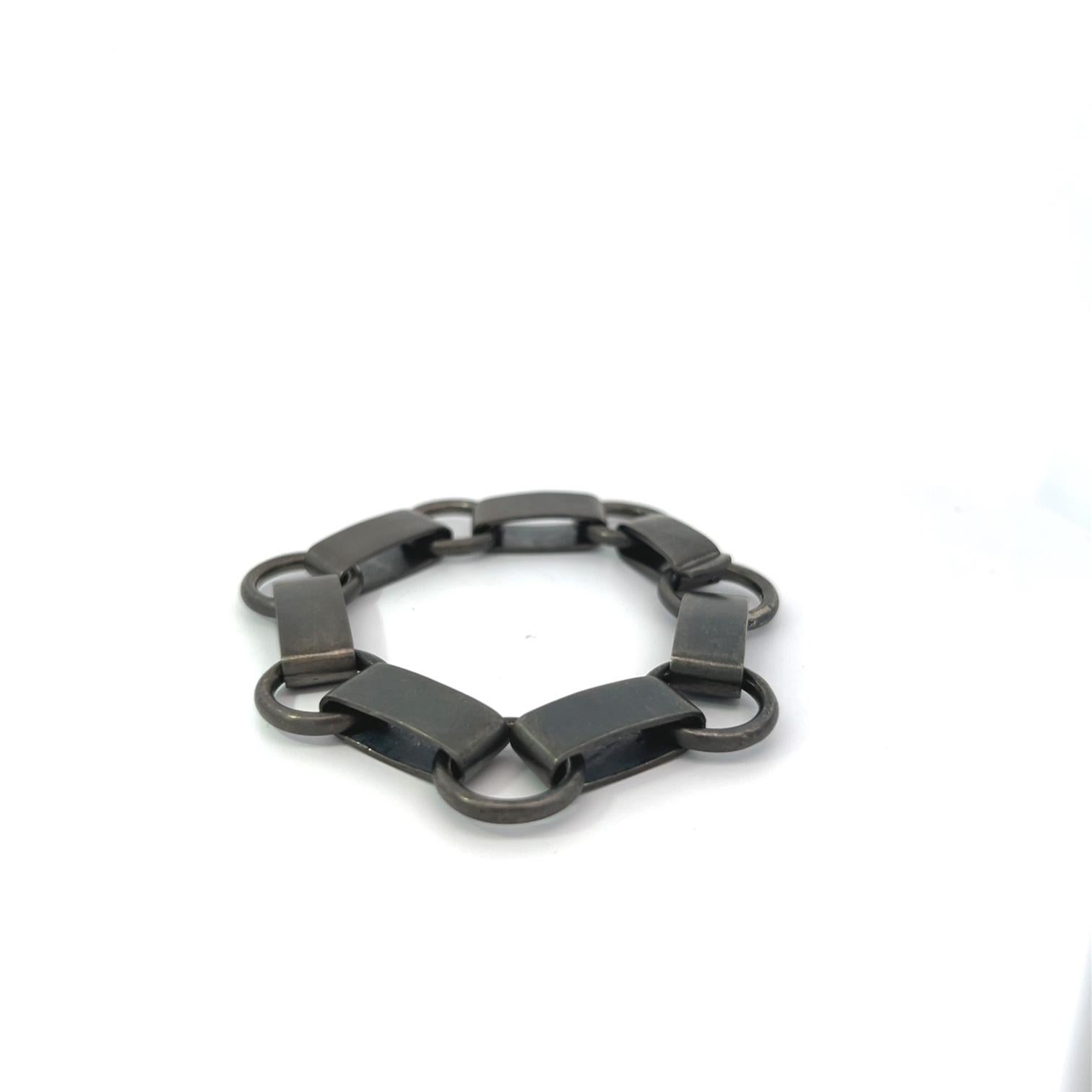 Scopri l'audace eleganza di questo bracciale a maglie in argento sterling fatto a mano, progettato con una finitura opaca e una placcatura in rodio nero per un tocco moderno e sofisticato. Caratterizzato da una sorprendente combinazione di maglie