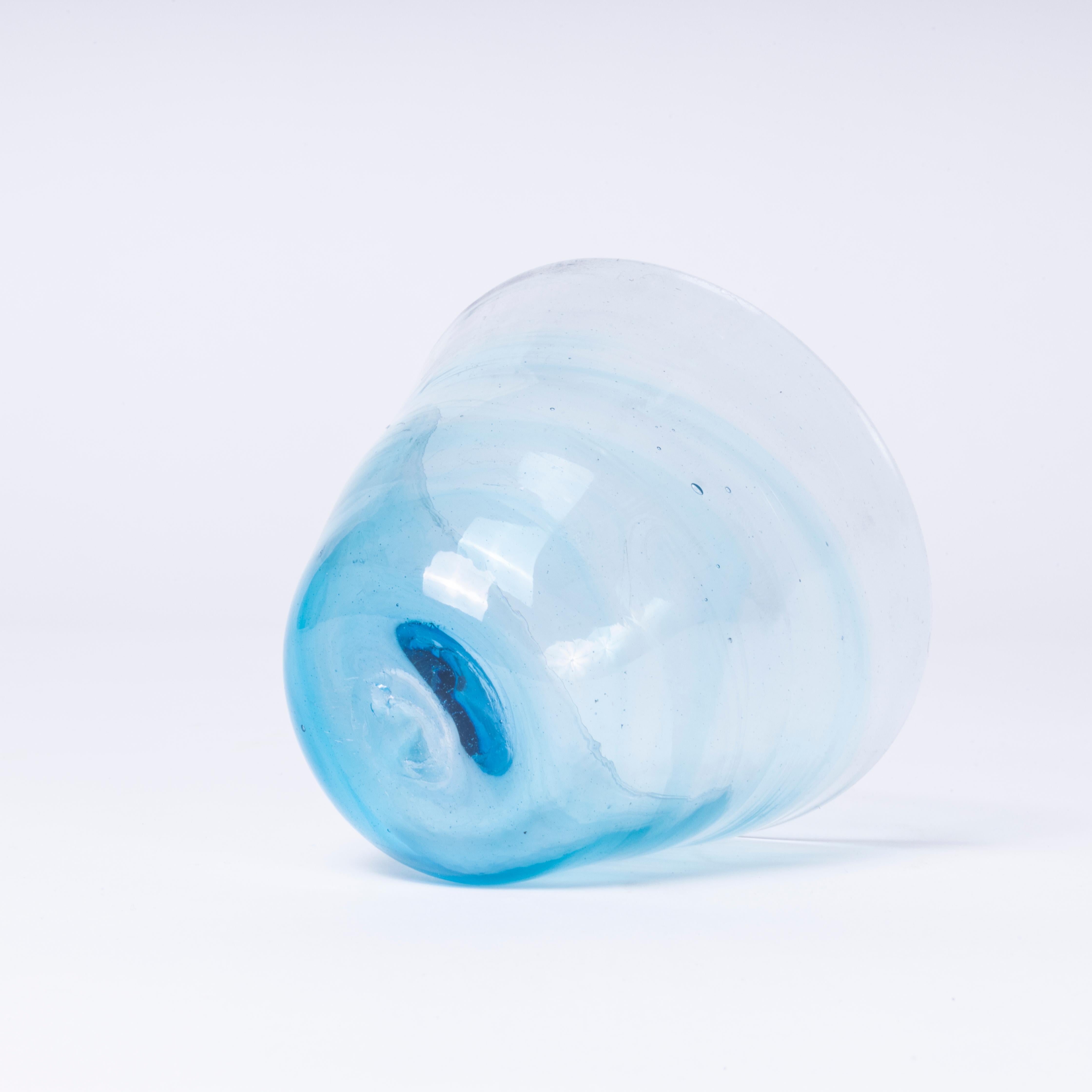 Contemporary Hand Made Moroccan Glass Bowl - Set Of Eight. Hand-made in Morocco. This set contains three amber, two green, one pink, one clear and one light blue bowls. The glass is mouth blown in a wonderful artisan quality. Because of the artisan