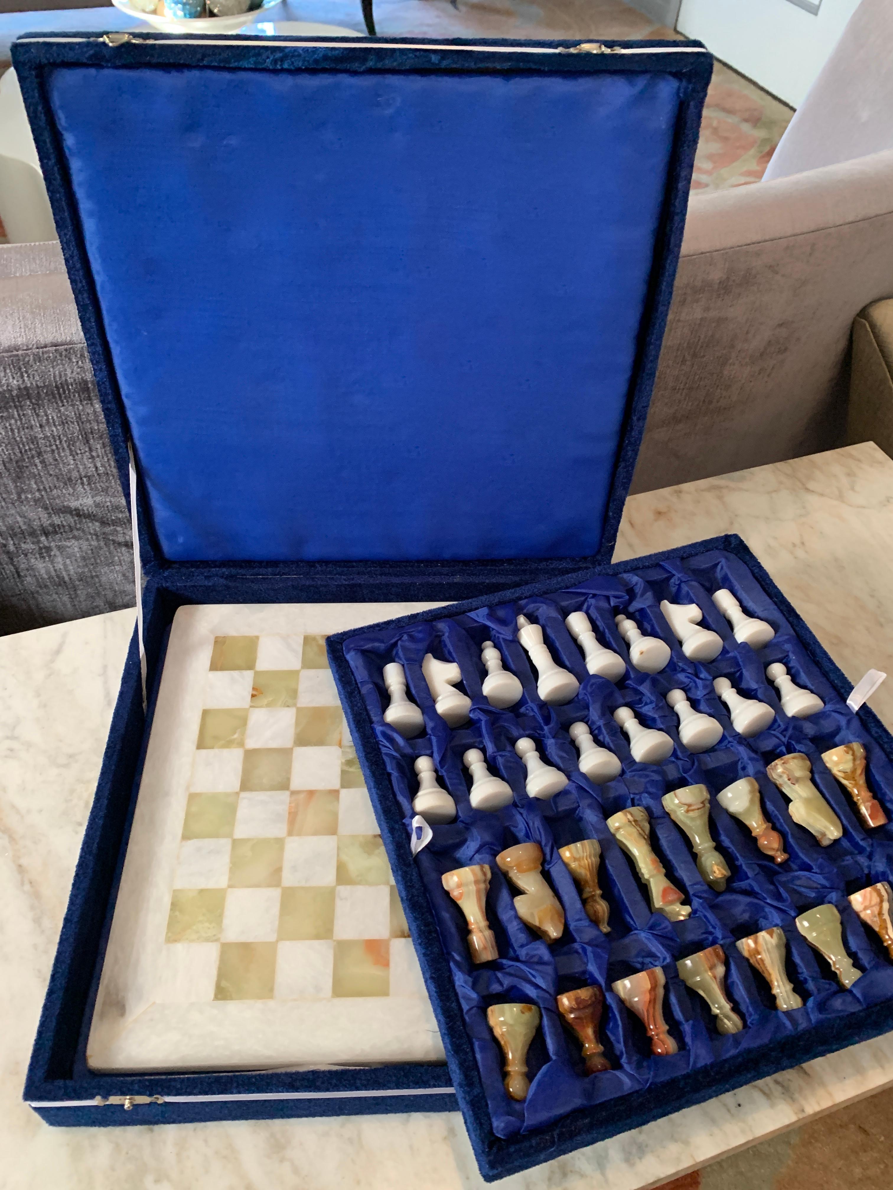 A completely handmade set of marble and onyx chess pieces and marble board, in handmade box. The decorative box that is included has been handmade of velvet and paper, a wonderful gift, family heirloom or the perfect travel chess set.

Measures: