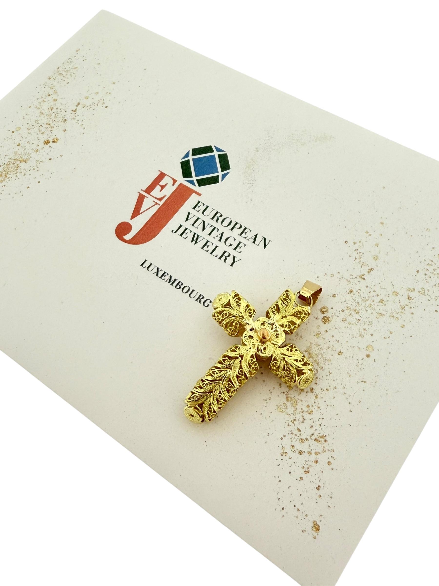 This exquisite hand-made cross is a stunning example of traditional Portuguese filigree craftsmanship, blending the warm tones of 18-karat yellow gold with the delicate hues of rose gold. The intricate filigree work showcases meticulous attention to