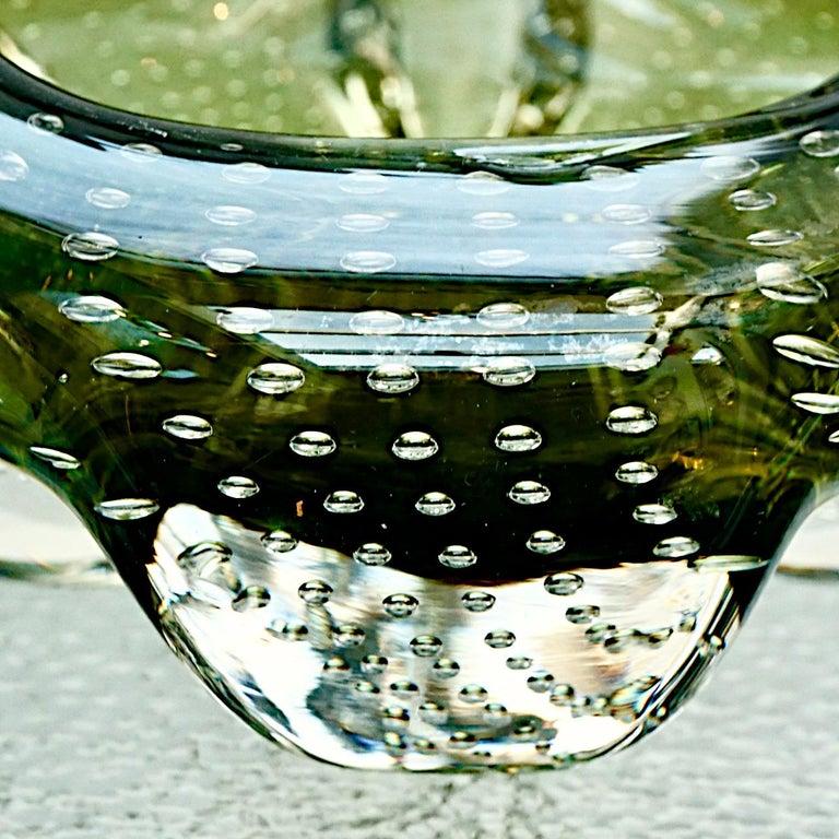 Heavy handmade art glass ashtray / bowl in a sage green and clear colourway, featuring controlled bubbles. The ashtray has a lovely curved organic shape. It is in very good condition, with some scratching. Measuring approximately diameter 13 cm /