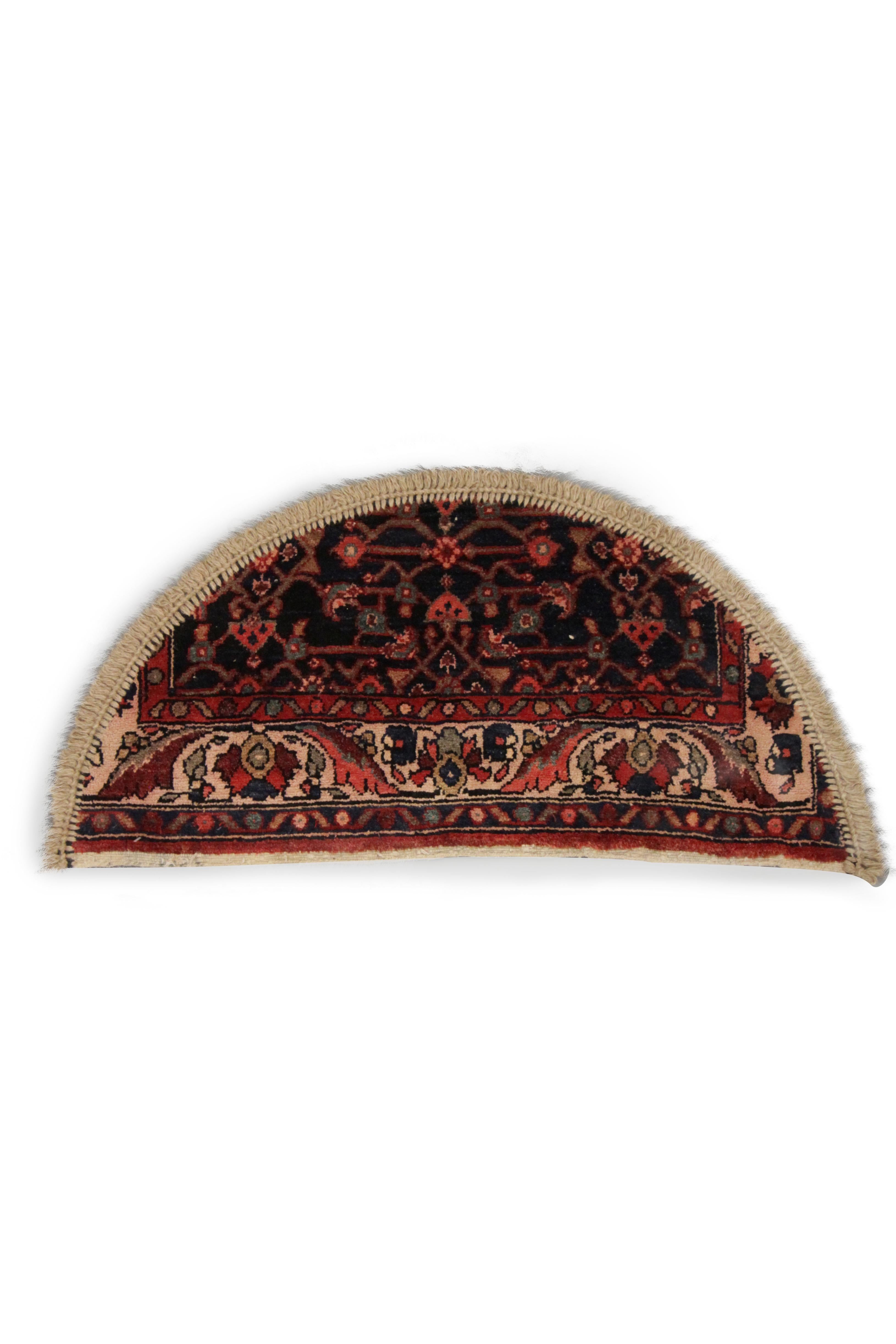 This handmade carpet layered design mixes floral and geometric motifs in various sombre colors, scrolling horizontally across this little area rug, perfect for use as a bedside rug or interior front doormat. This semicircle entranceway doormat has