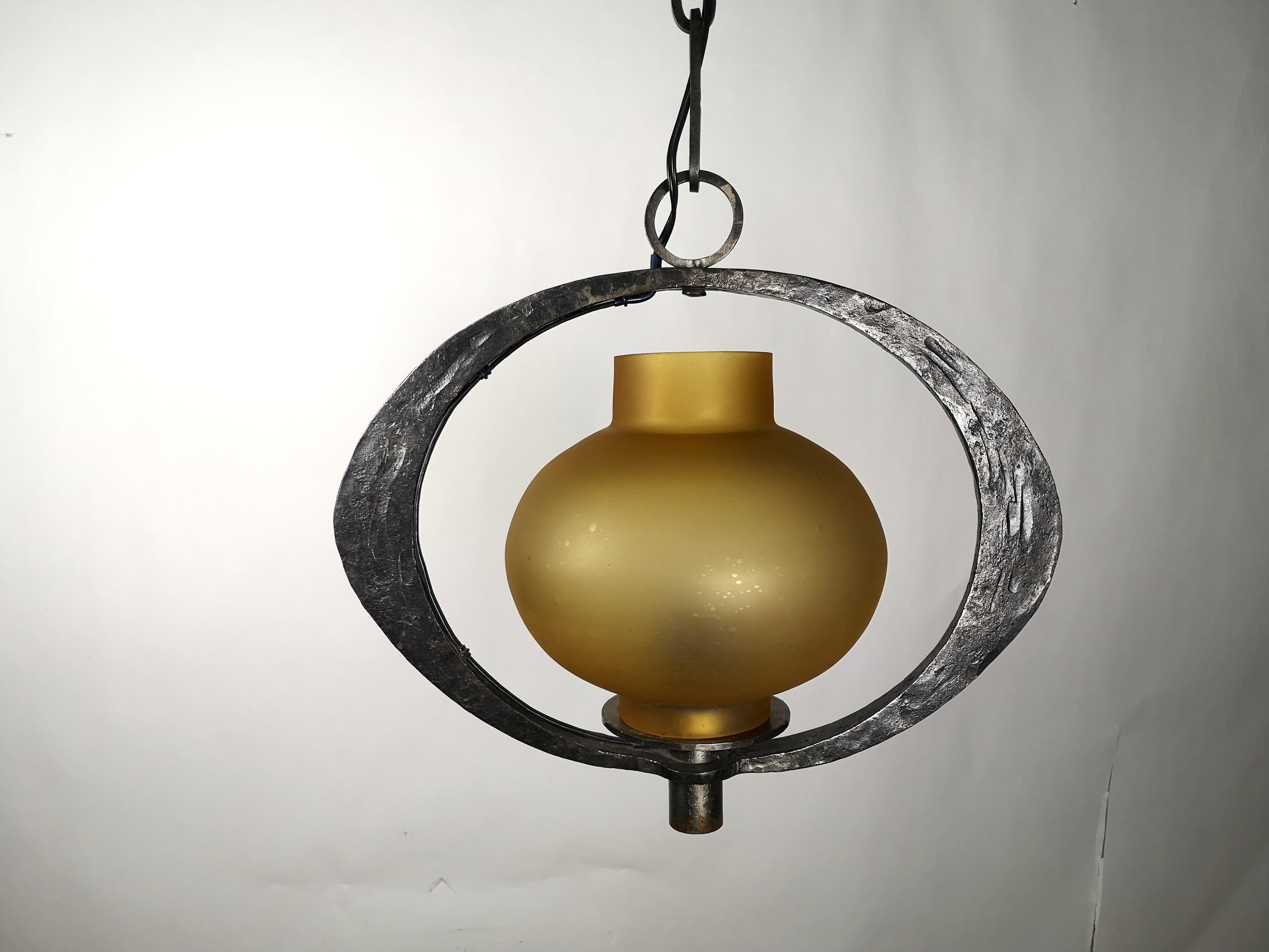 Handmade Hungarian wrought iron chandelier with unique glass bulb, 1970s, signed by artist Janos Lehoczky.