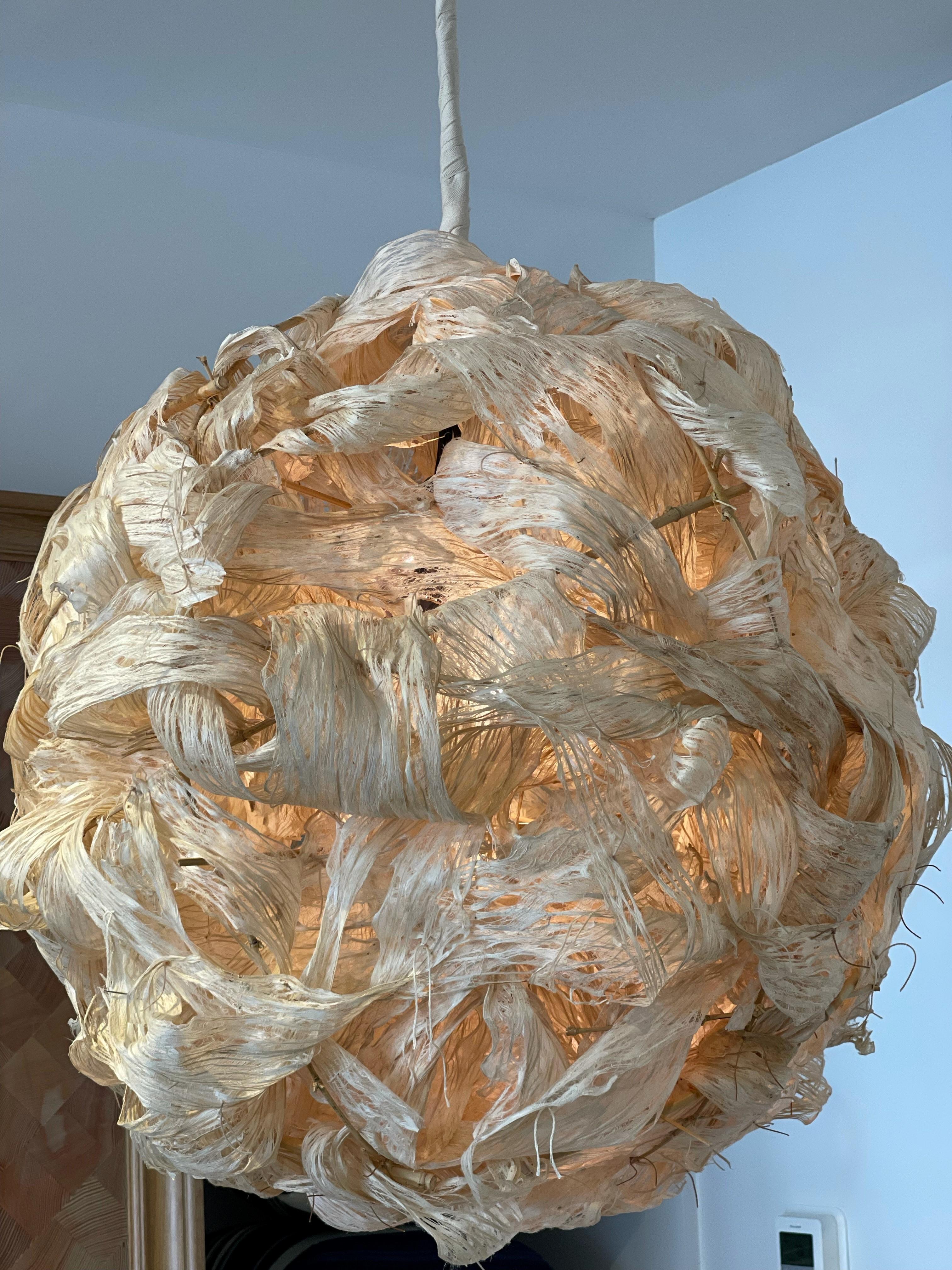 This is a hand crafted chandelier made out of kozo bark lace. Made by a local artisan and currently on display at our shelter island store. It is in 33