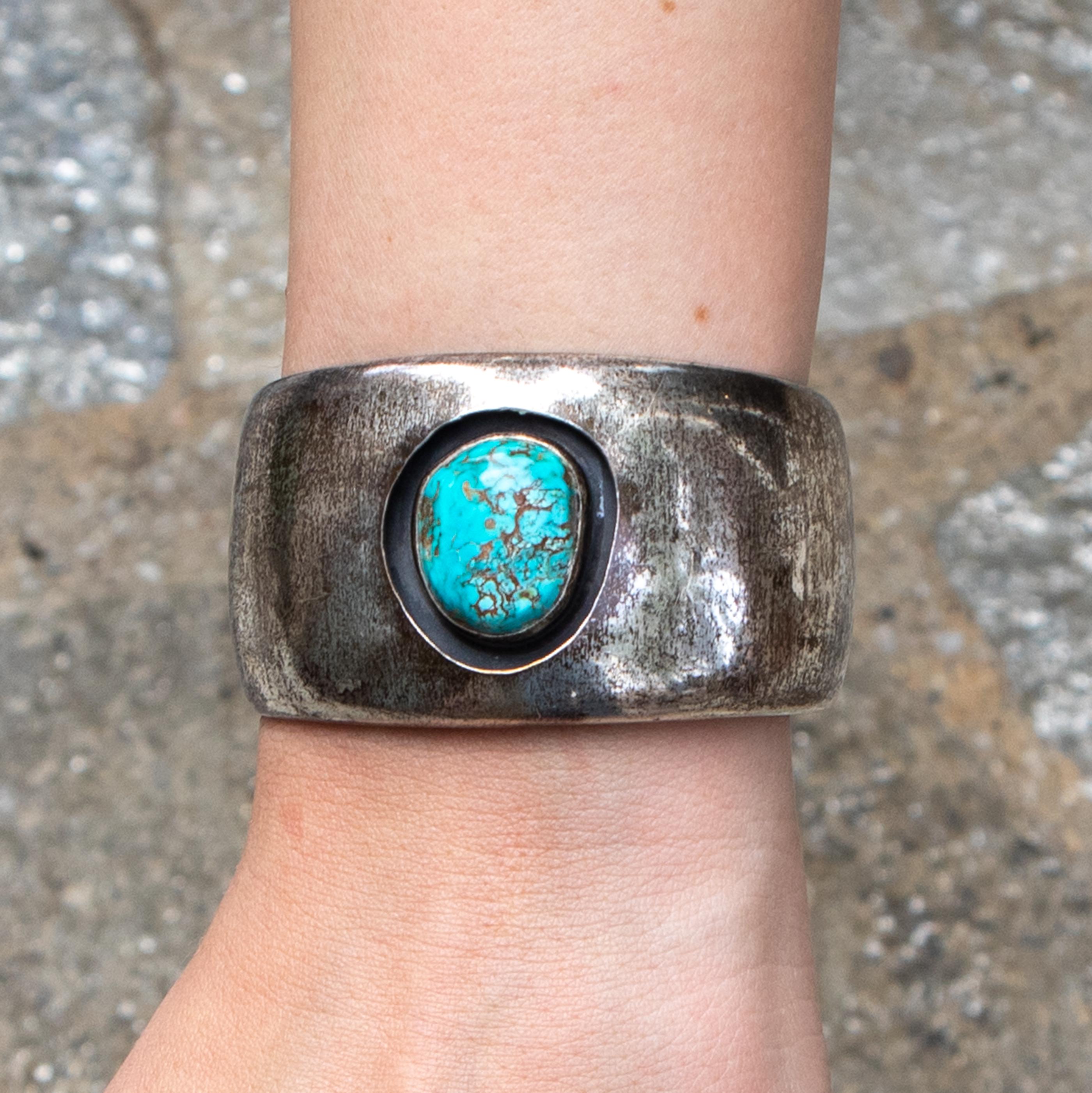 Beautiful sterling silver cuff bracelet with a large piece of antique turquoise. This will always add a little bit of flair to any outfit. 
Hand Made 
Sterling Silver 
Turquoise
