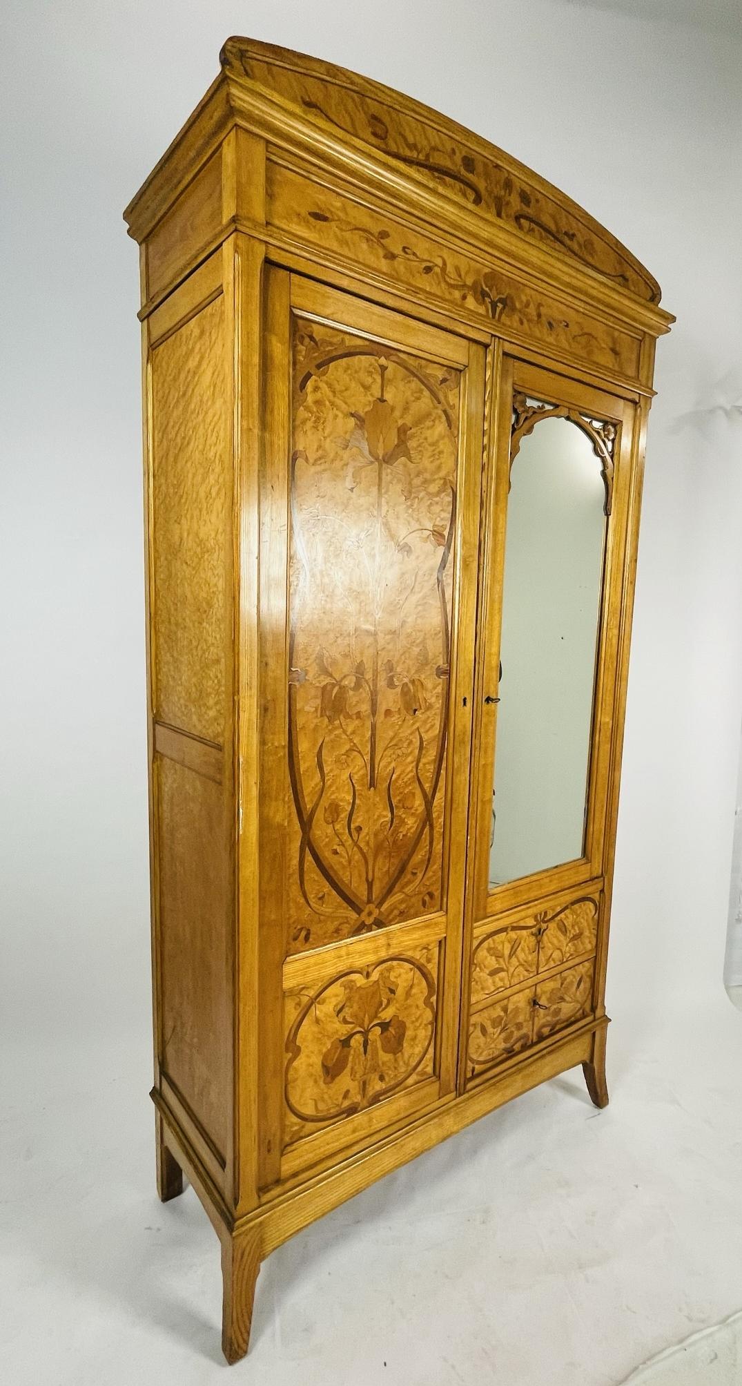 Introducing a stunning piece of furniture that will elevate any room's decor - the Hand-Made Tall Armoire made in France, Early 1900s. This armoire is a rare find, crafted with care and precision by skilled artisans in France over a century