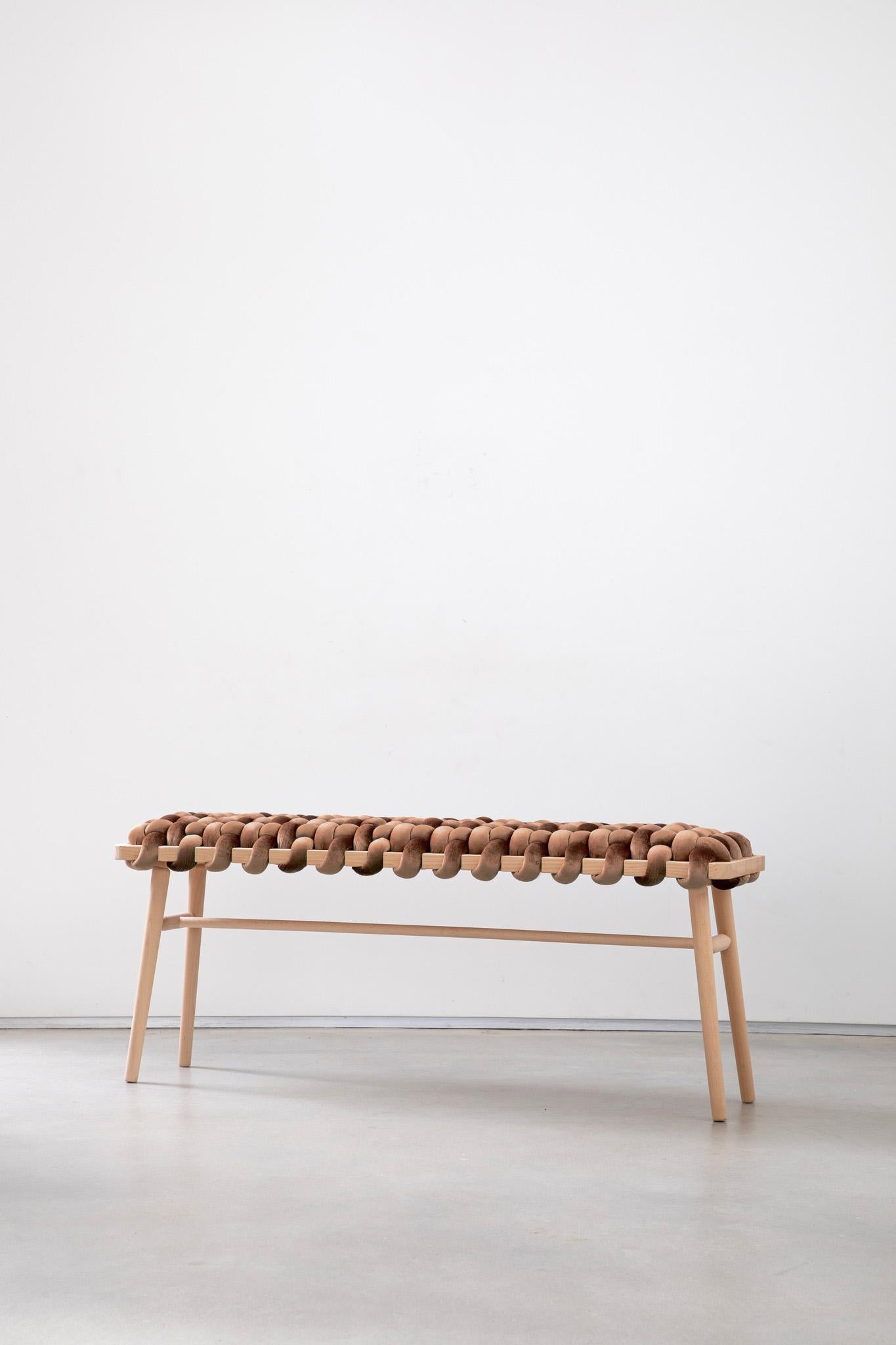 Born of appreciation for elegance, the woven bench is a handmade piece that brings a sculptural, playful air to any entryway or living space. Each bench is crafted with care using a weaving technique that blends fine velvet fabric and natural