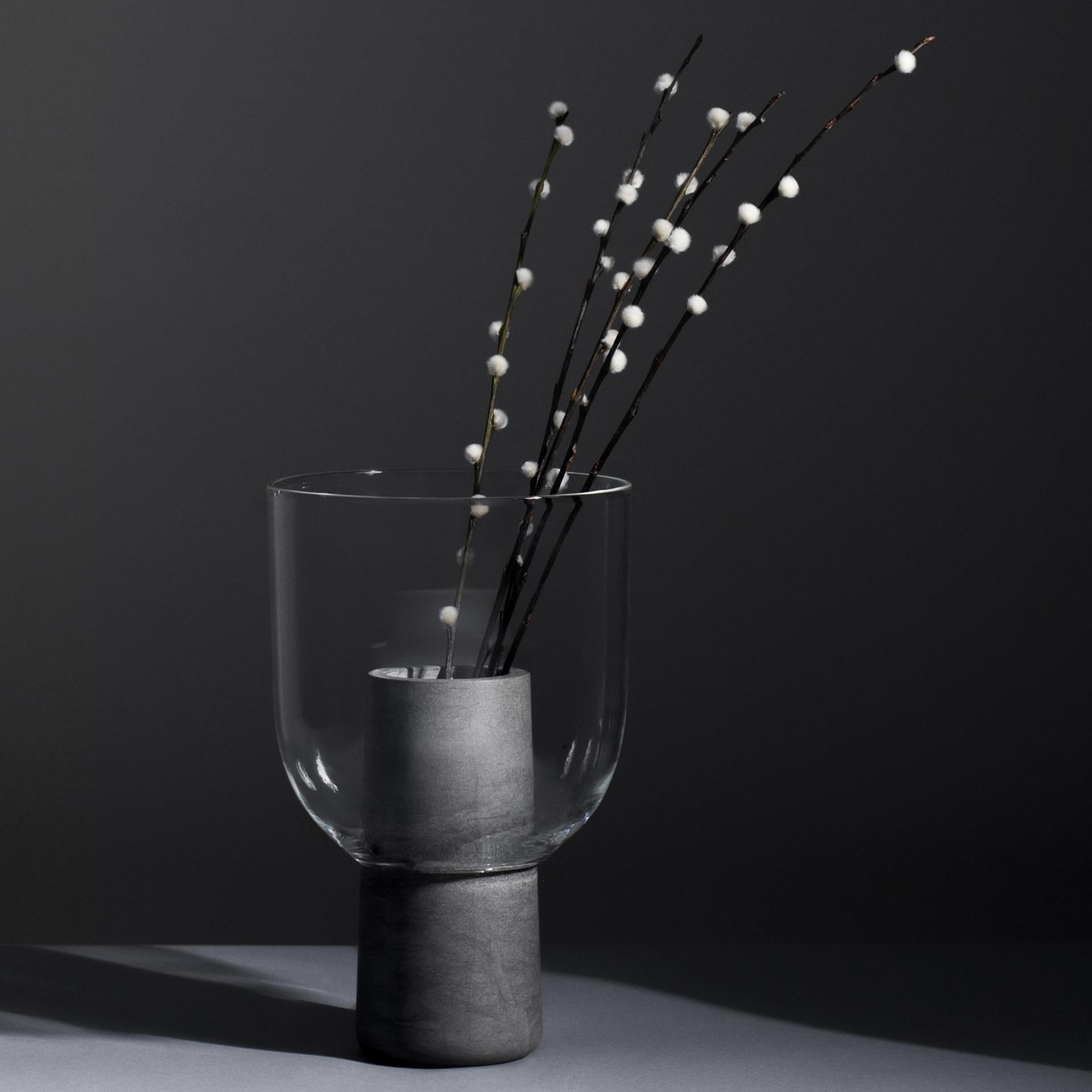 A glass and marble vase to add a touch of softness and detail to the interior. The thin and delicate material of the top contrasts the marble body of the base and creates a layered silhouette. The word 