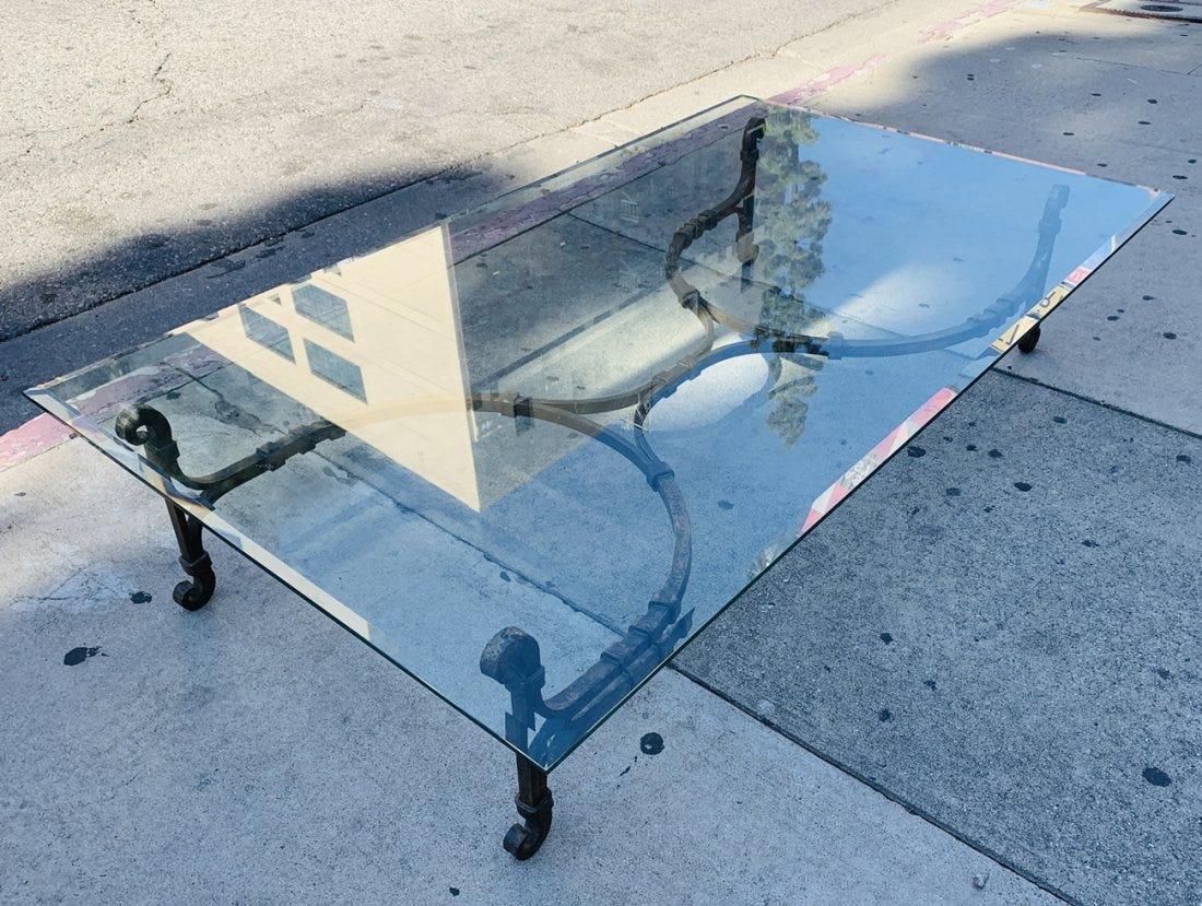 Stunning wrought iron coffee table with a gold gilt finish. The base has beautiful architectural lines, very well designed and executed.

The base is topped with a 3/4 thick glass top.

The bottom of the table has 153/936 and Monaco Gold written