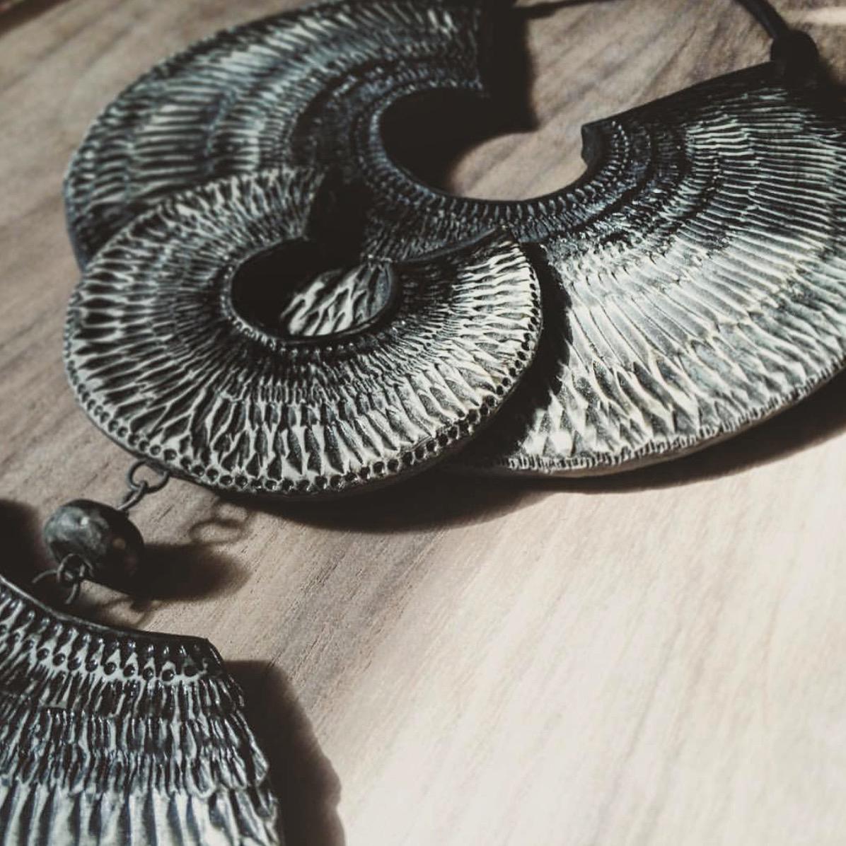 This hand marked wall hanging is carefully constructed from carved porcelain with a black glaze and leather strap. The piece is a meditative journey, with intricate patterns mimicking those found in nature. 

A unique wall piece that strays from the