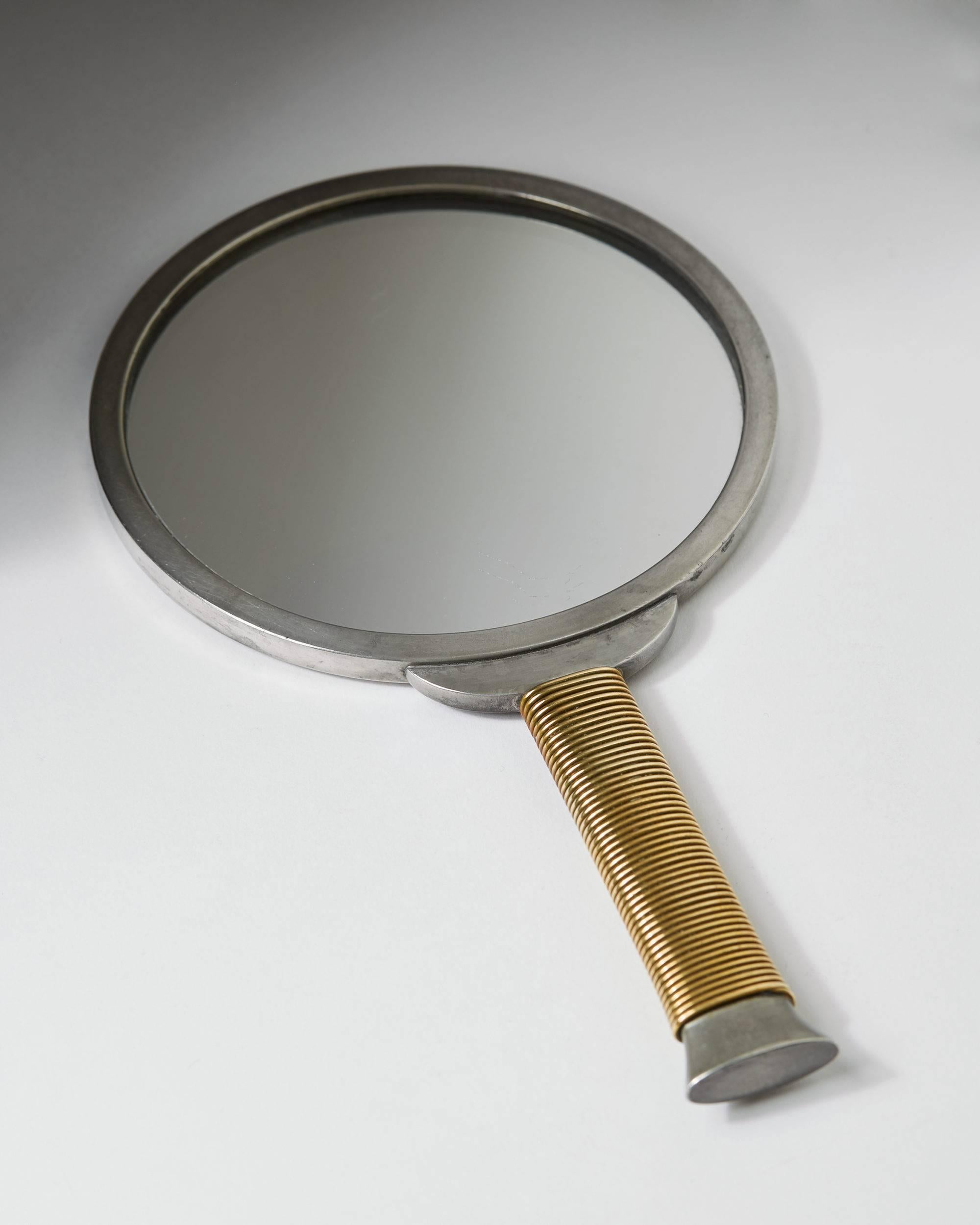 Hand mirror designed by Estrid Ericson for Svenskt Tenn, 
Sweden, 1930s.

Pewter and brass.

Measures: L 22 cm/ 8 3/4