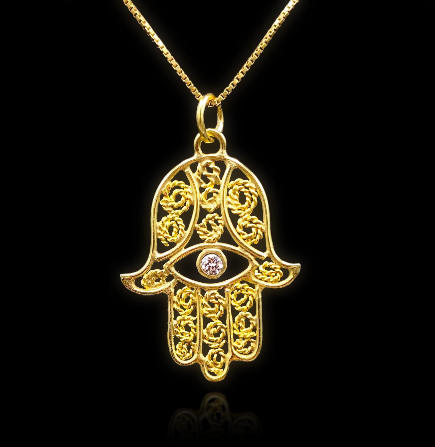 - Available
-Handmade
-18k gold frame.
-22k gold filigree wire.
-D-G VS1 0.107 carat diamond.
-This item is sold as a pendant only.

One-of-a-Kind Hand of Fatima Pendant

The Hand of Fatima, also known as Khamsa (Arabic for the number 5) or Kaf