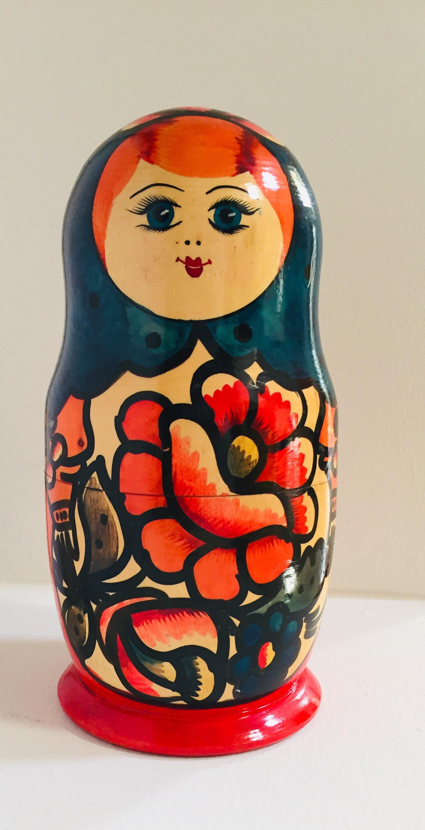 Vintage hand painted and carved Neasting dolls in traditional costume, woman wearing head scarf and traditional robe with baby girls.
Traditional hand painted beech wooden Matryoshka nesting dolls.
This Matryoshka dolls are made of beech wood with