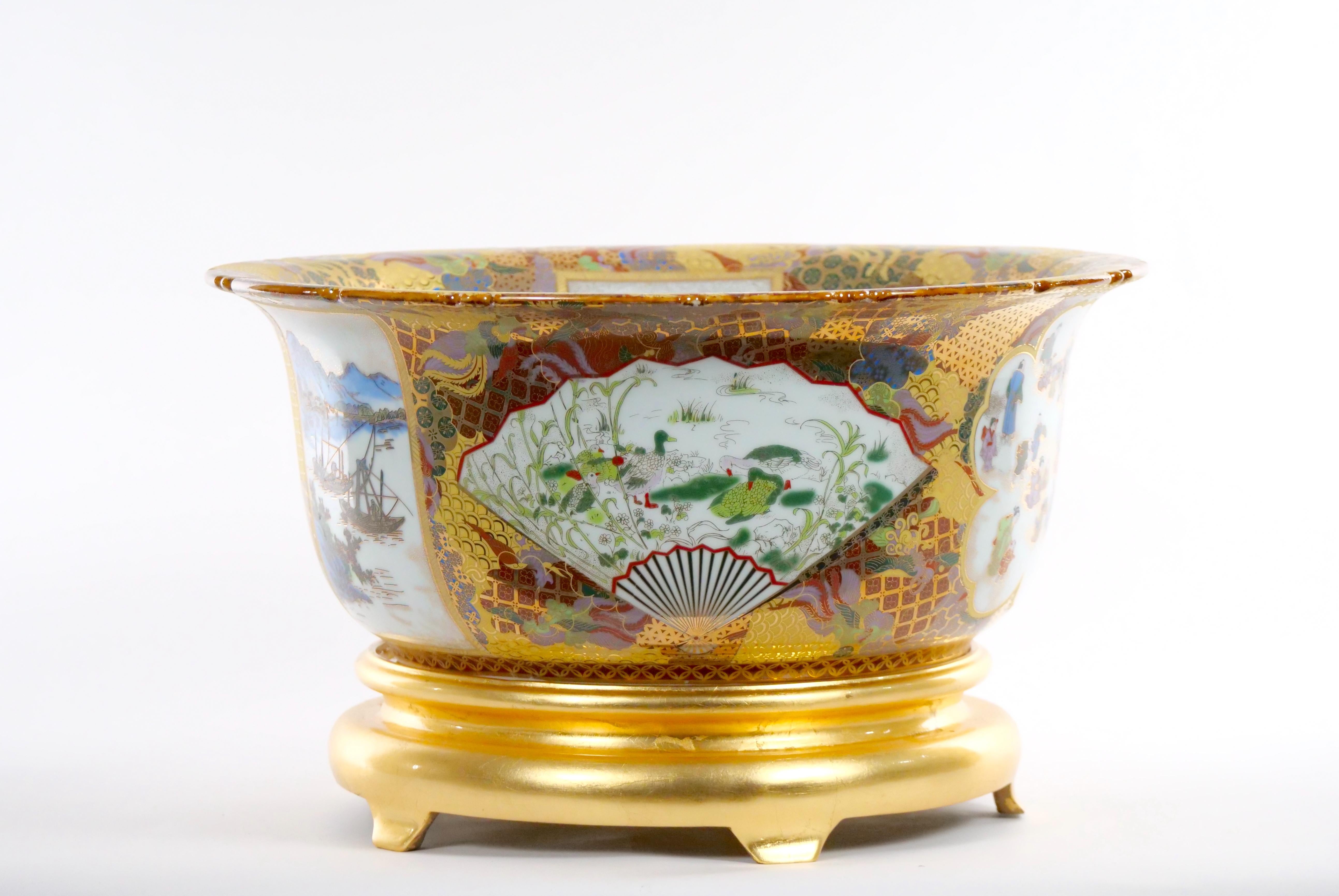 Very large Chinese export porcelain centerpiece bowl (or fishbowl) of the finest quality with giltwood stand. Featuring enameled decorations and cartouches in the shapes of fans, flower heads and rectangles, depicting boats at sea, monkeys nestled