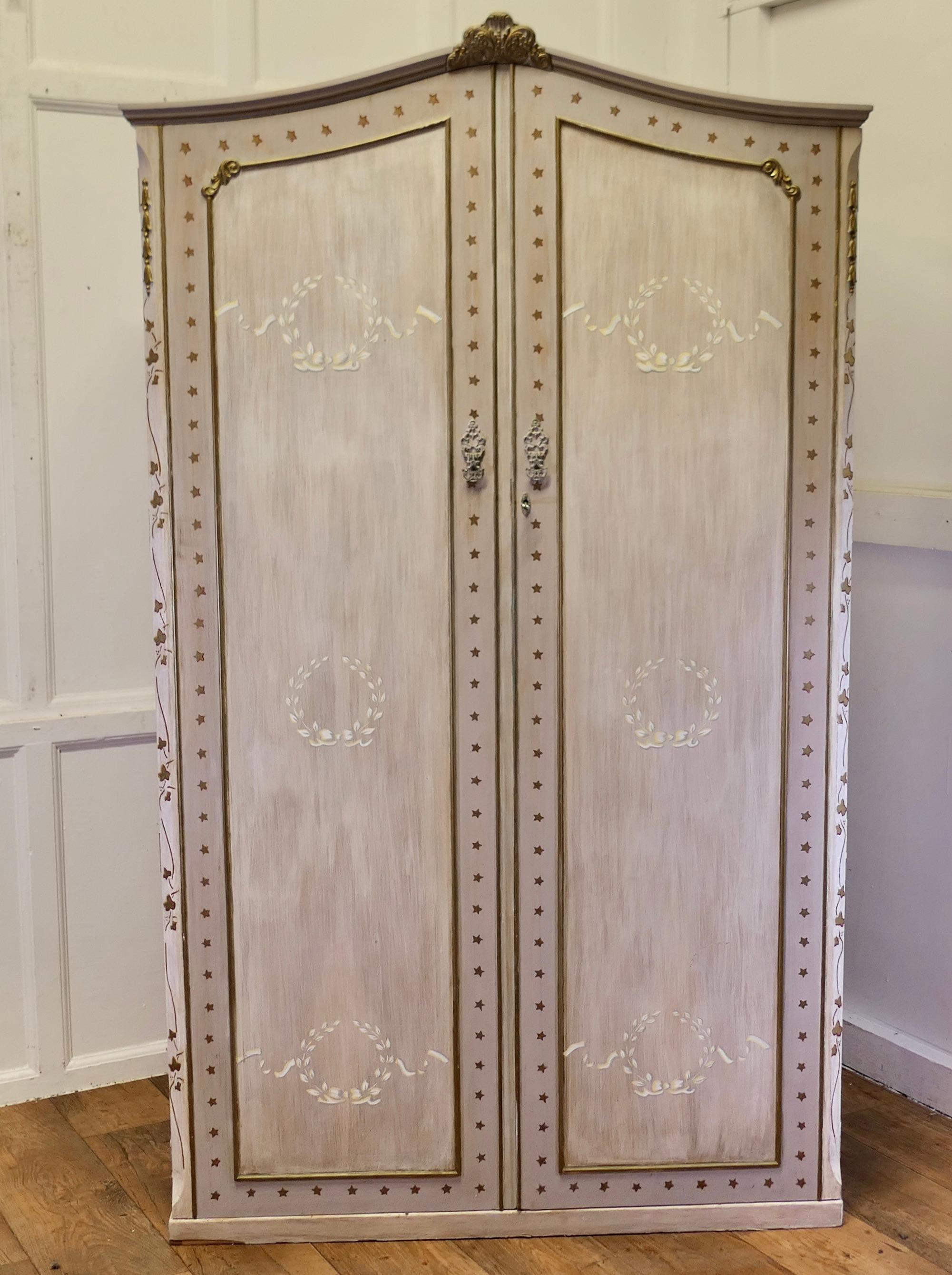 Hand Painted Armoire/Compactum from South of France

Beautifully painted and unrestored French Country wardrobe, this is a tall piece with a dome shaped top and 2 doors. Inside on the right hand side it has a hat shelf at the top 4 small glass