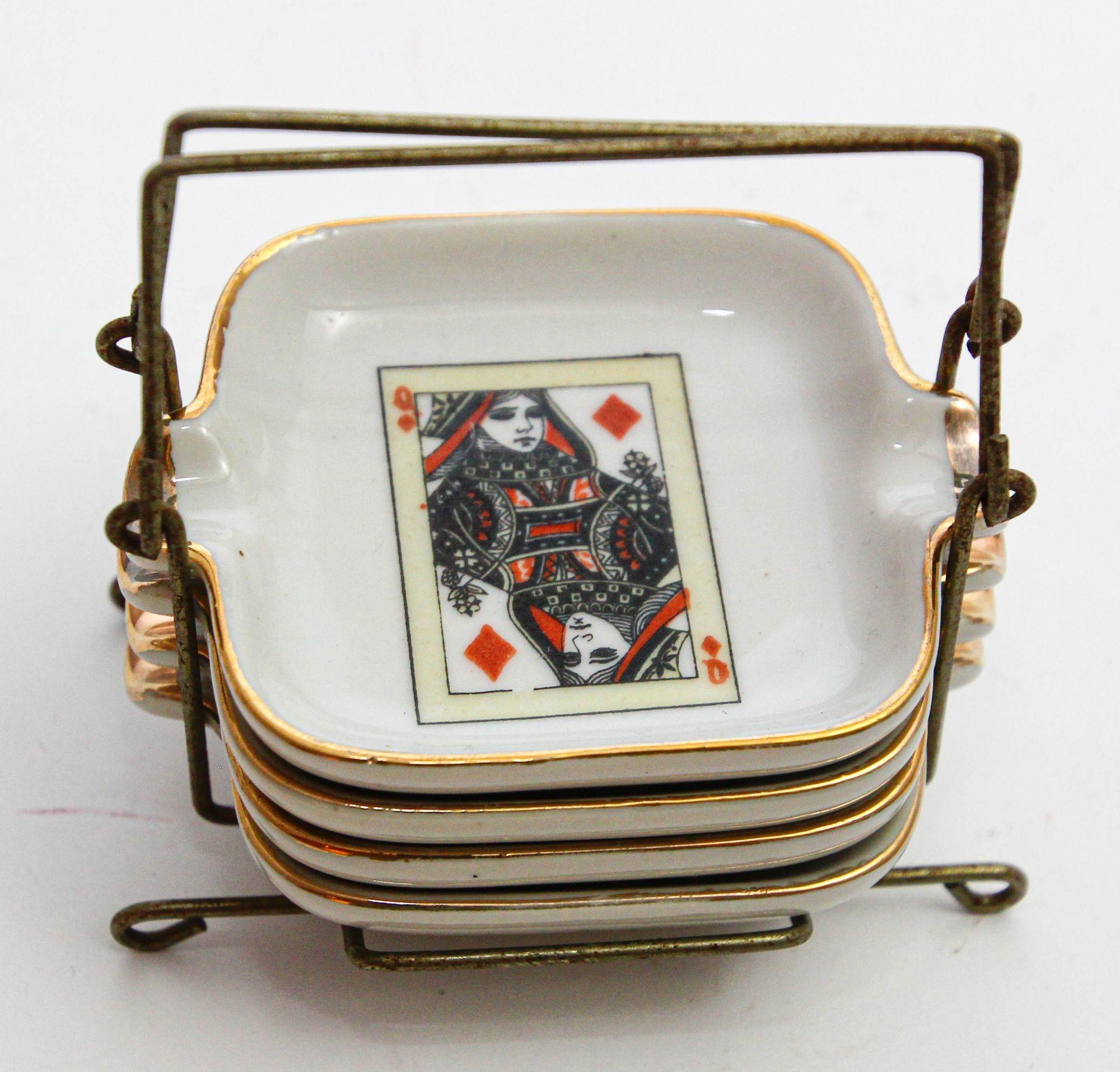 Hand-Painted Limoges Style Porcelain Ashtray from 1960s France.
Set of 4 Poker Bridge Playing Cards Ashtrays in Metal Tray Holder, Collectible.
Vintage Set of 2 Kings and 2 Queens Playing Cards Porcelain Ashtrays with Golden Trim.
French Porcelain