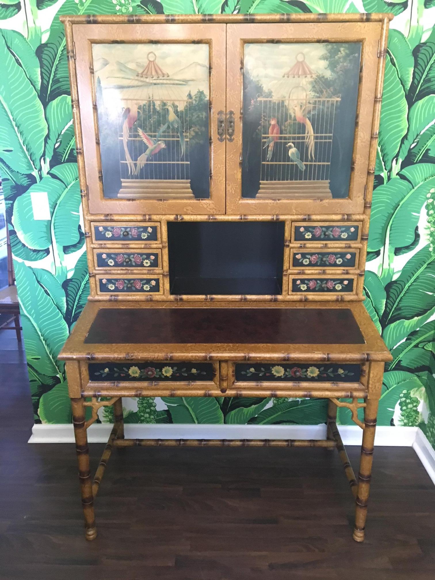Asian chinoiserie faux bamboo desk with hutch and matching chair features hand-painted tropical motif. Leather embossed desk top and bronze hardware. Desk and hutch are two separate pieces. All pieces in good condition with minor cosmetic issues