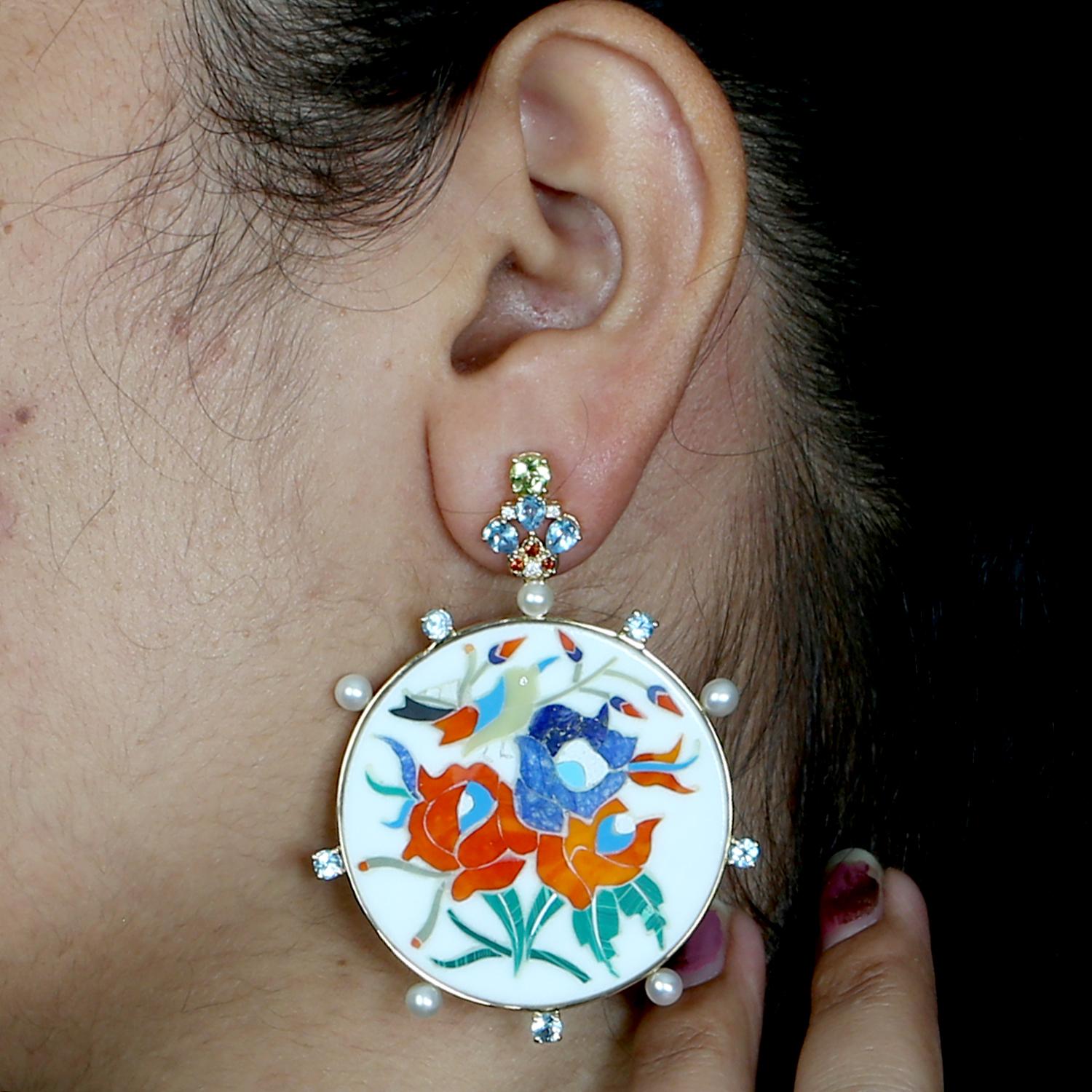 Description
These exquisite drop earrings by Artisan feature 56.10ct of hand-painted bakelite panels enriched with vibrant 0.15ct garnet and 4.14ct pearls, delicately accented by 0.13ct of diamonds in a setting of 10.057g of 18K gold. The
