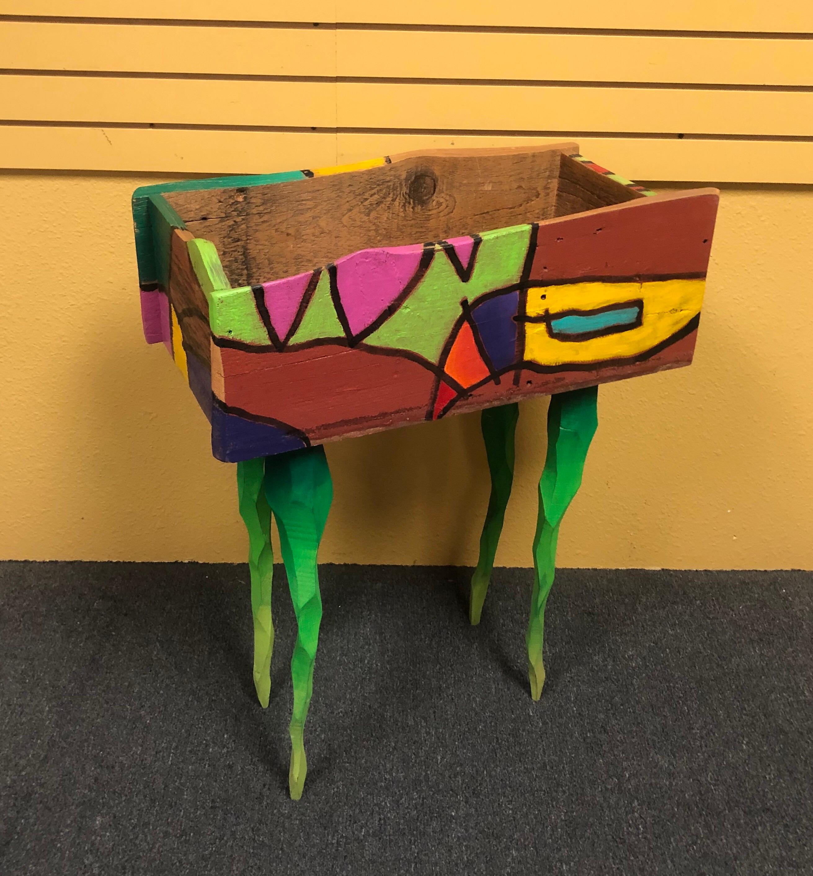 Hand painted barn wood planter by noted artist, author and furniture maker Brian Andreas, circa 2000s. This super colorful large planter is on a stand of green twisted legs and measures: 26.5