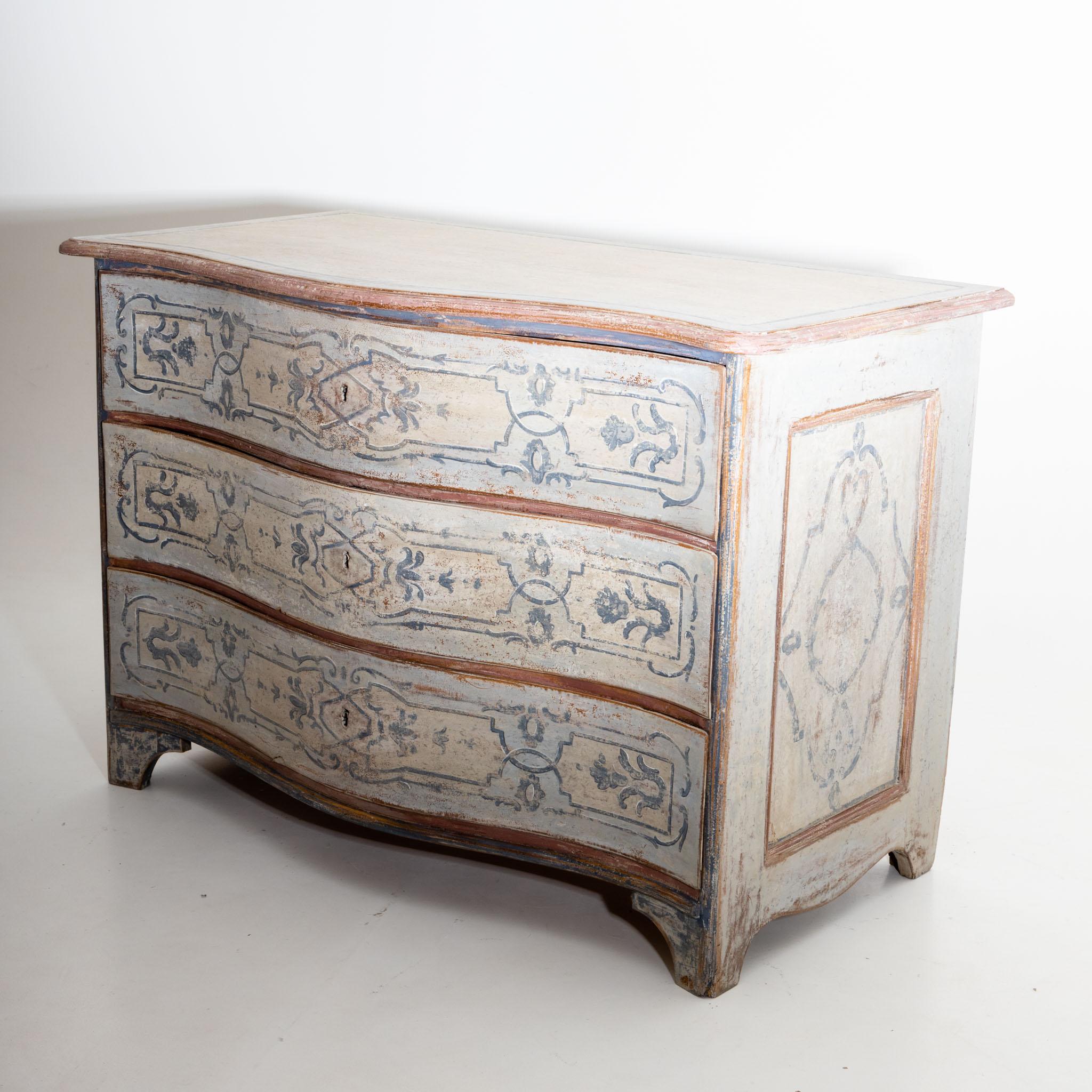 Hand painted Baroque commode in the French Provincial style with a curved front and coffered sides. The new setting in blue and brick red has an antique patina.