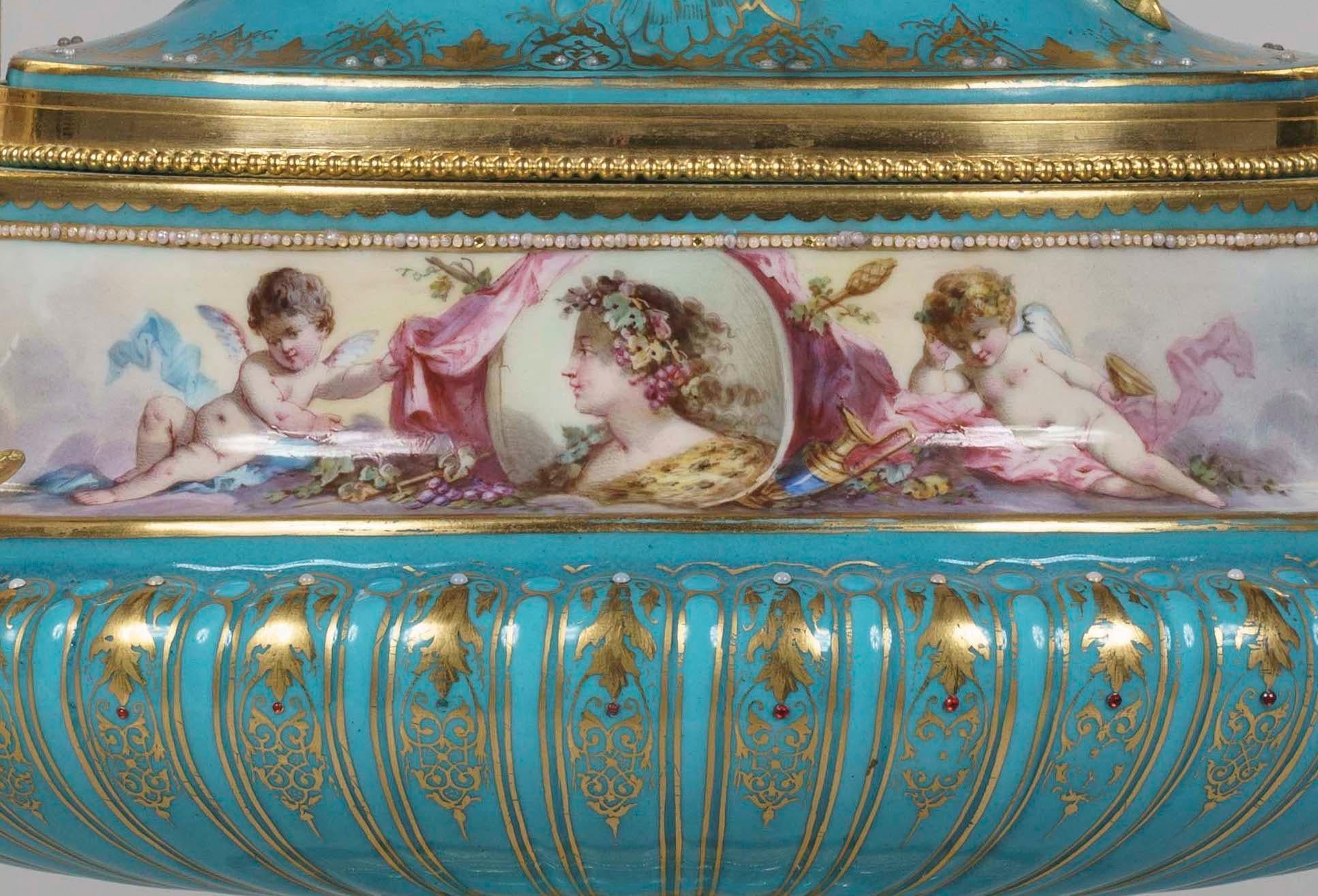 A hand painted and ormolu-mounted
‘Sèvres’ Porcelain urn in the Louis XVI Manner

The characteristic bleu celeste Sèvres-style porcelain body of oblate and bulbous form with gadrooned base bearing glass bead embellishments and mounted with