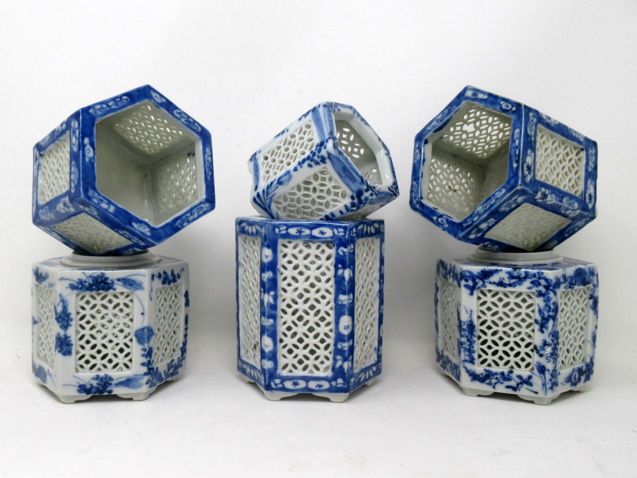 Stylish assembled set of six hand painted Chinese or Japanese Export reticulated or lattice pierced blue and white porcelain vases of hexagonal outline, circa first half of the 20th century. 

Each finely hand decorated on all outer panels