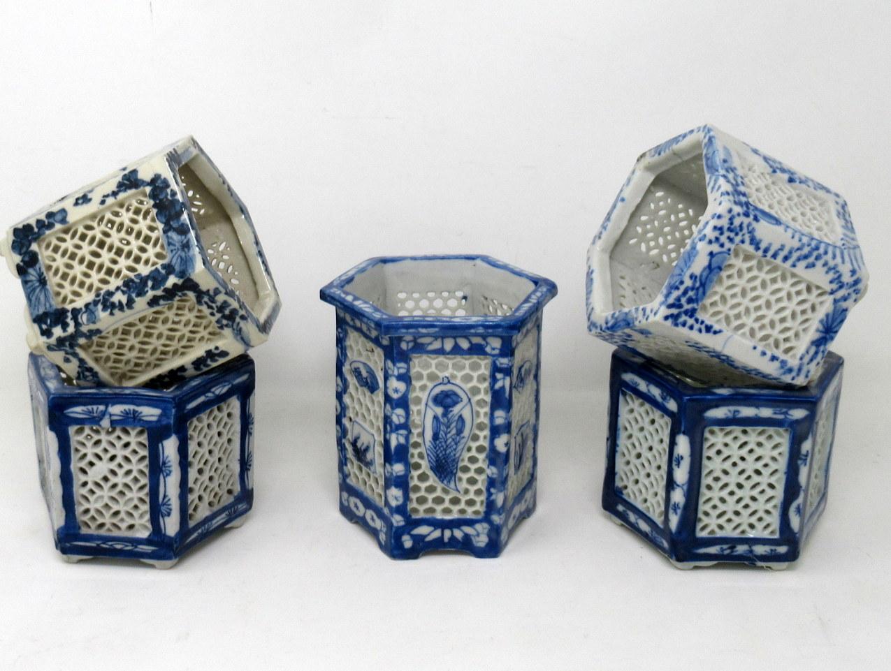Stylish assembled set of five hand painted Chinese export reticulated pierced blue and white porcelain vases of hexagonal outline, sometimes referred to as cricket pots or cages. Circa first half of the twentieth century. 

Each finely hand