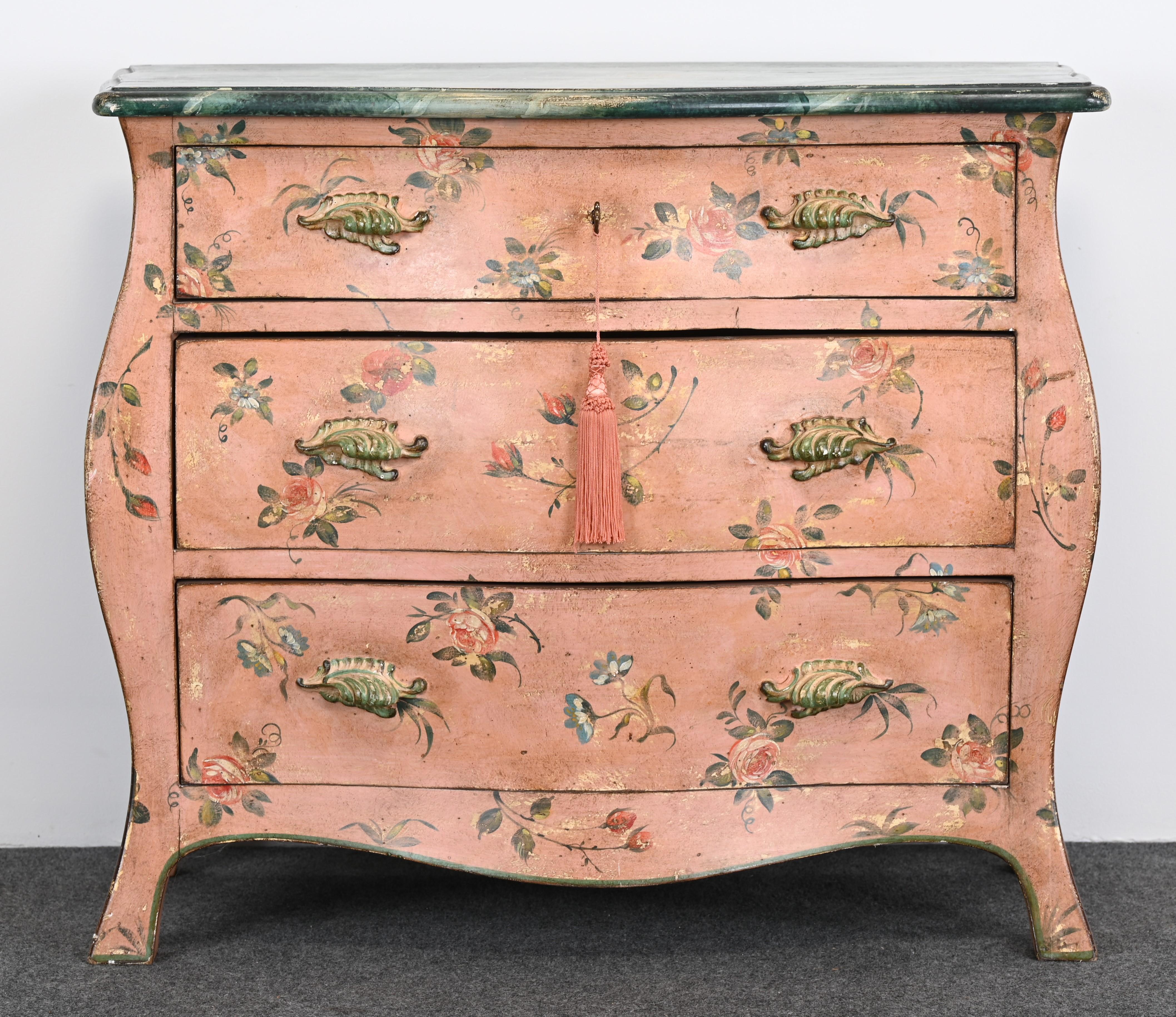 A lovely hand-painted Bombe or Bombay Chest of Drawers by Patina Furniture Company, 1980s. This Italian chest has a beautiful hand-painted aged patinated finish and a faux marble top. The chest has nice carved handles with a brass key that has a