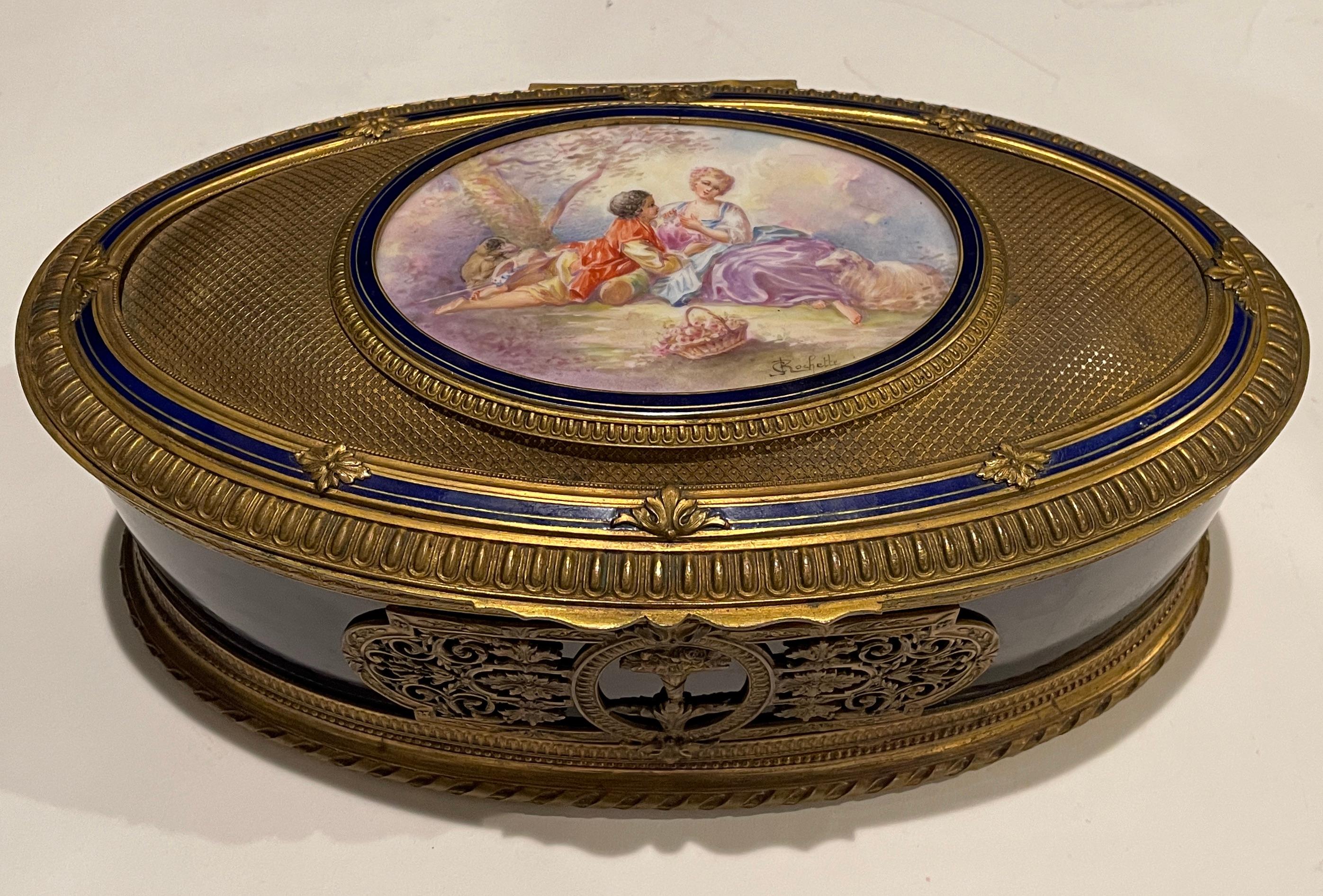 French 19th century French hand painted and gilt bronze mounted cobalt blue box. Artist-signed by J.C. Rochette – a well known artist who worked at the Sévres factory with her father A. Rochette in the later half of the 19th Century.