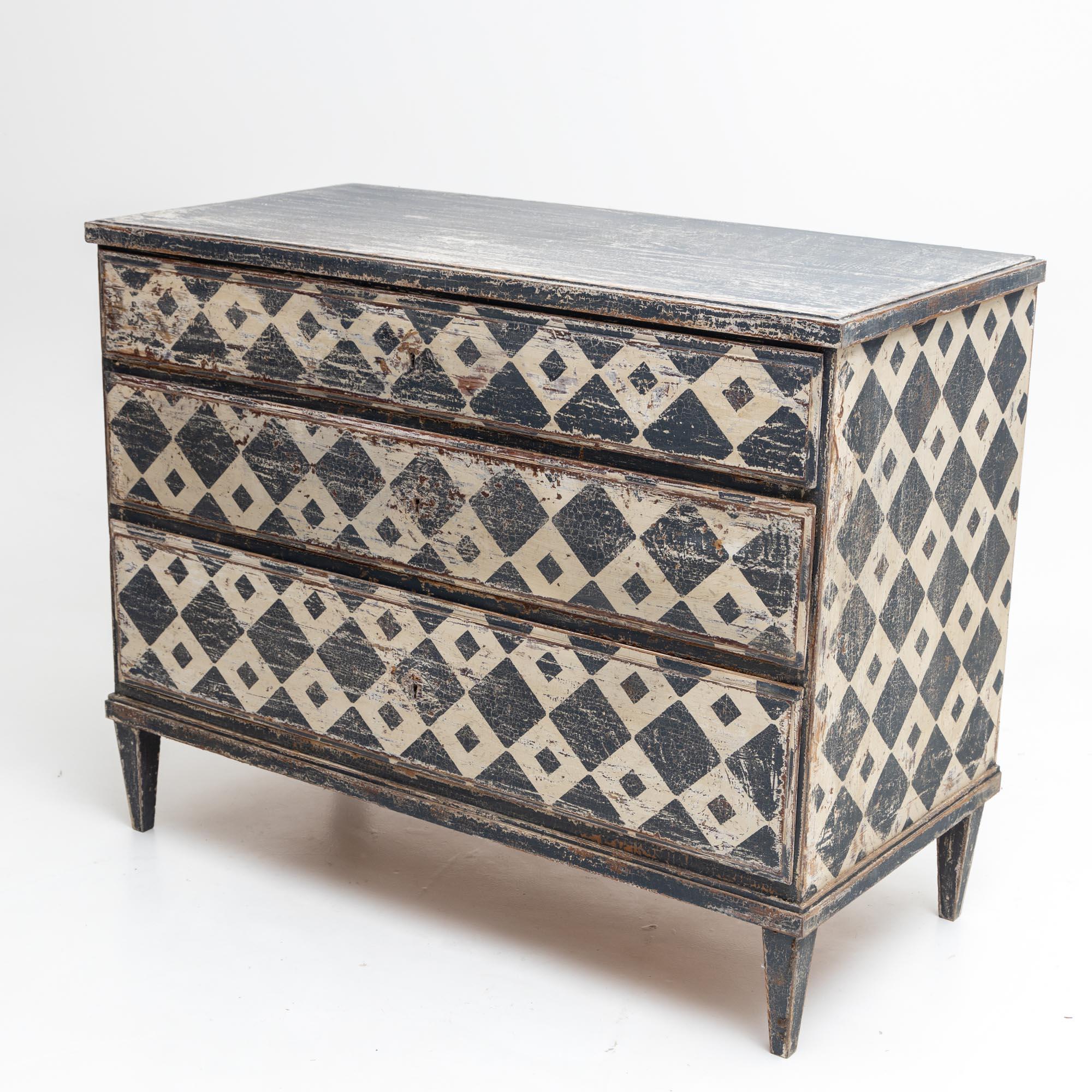 Hand-painted chest of drawers with three drawers and a straight body. This chest of drawers was repainted according to historical models with a diamond pattern in white-grey and patinated in antique style.