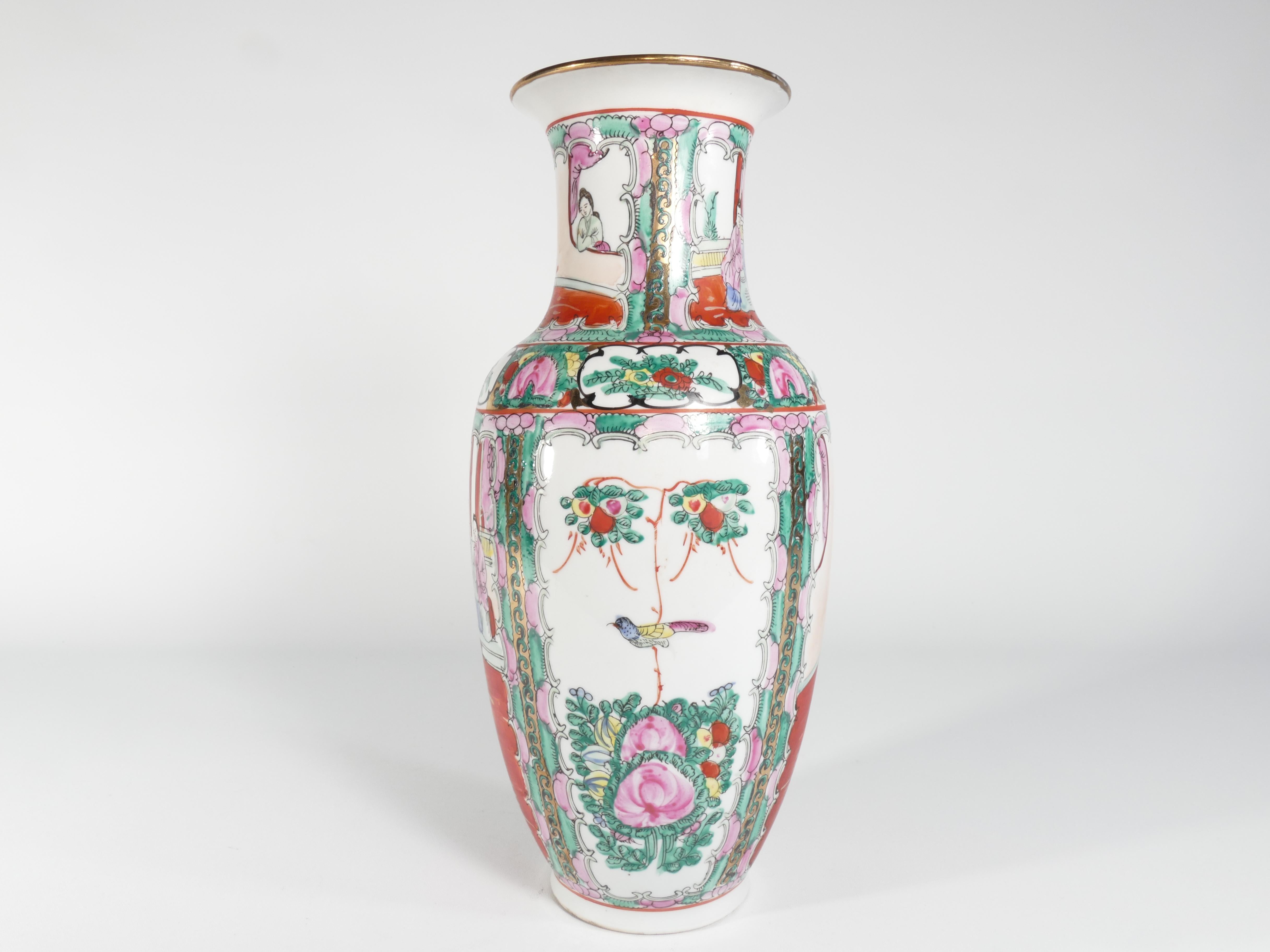 A sizeable Chinese Famille Rose Medallion vase. This vase is hand-painted with the traditional Chinese Rose Medallion motif, incorporating red, pink, and green hues along with gold, yellow, black, and blue accents. The vase body is divided into four