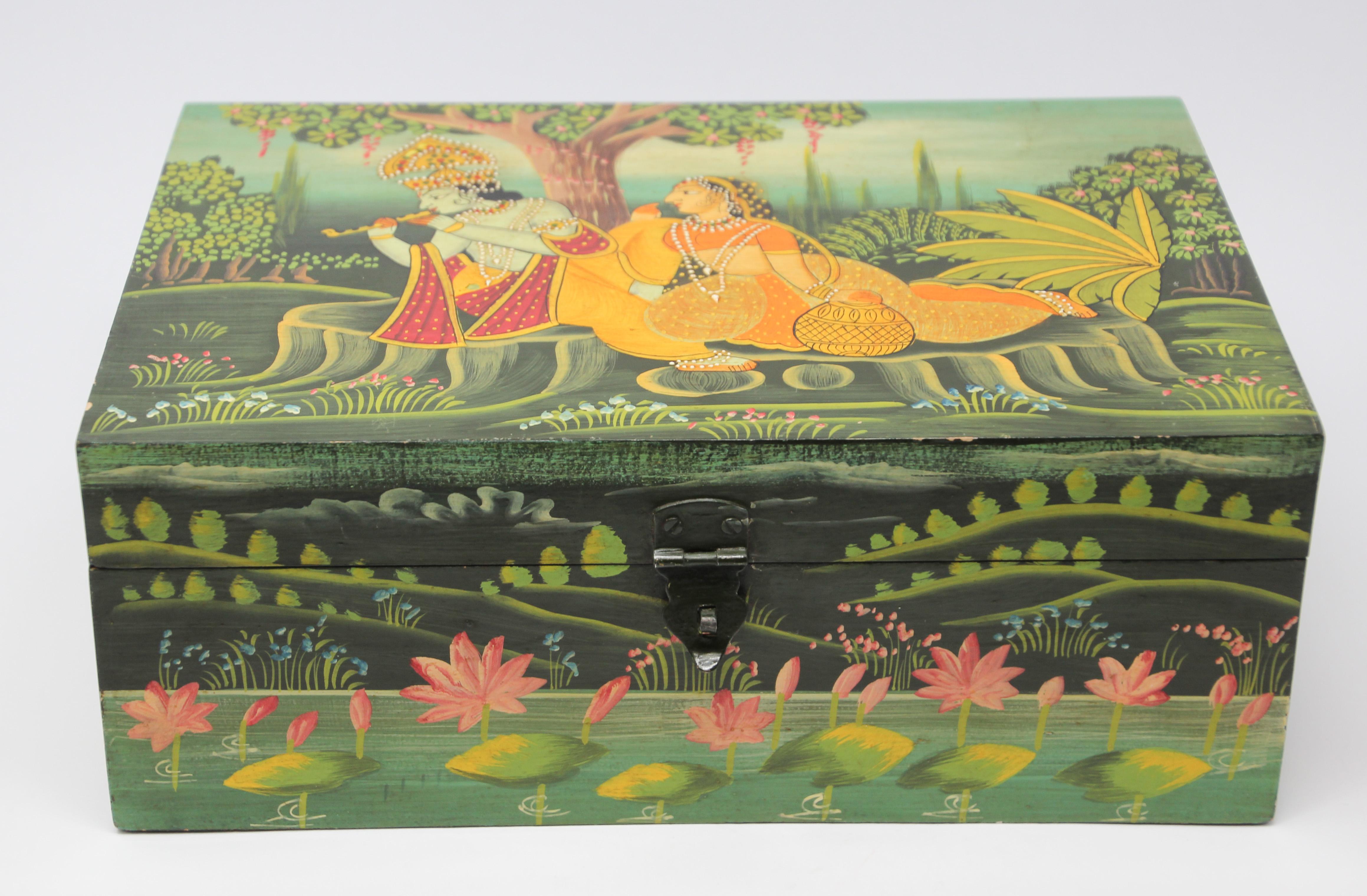 Hand painted wooden box.
Incredibly intricate, highly detailed and colorful handcrafted wooden box with Krishna playing the flute and a female figure.
Colorful painting depicting Krishna with female Gopis, great colors, the composition is enclosed