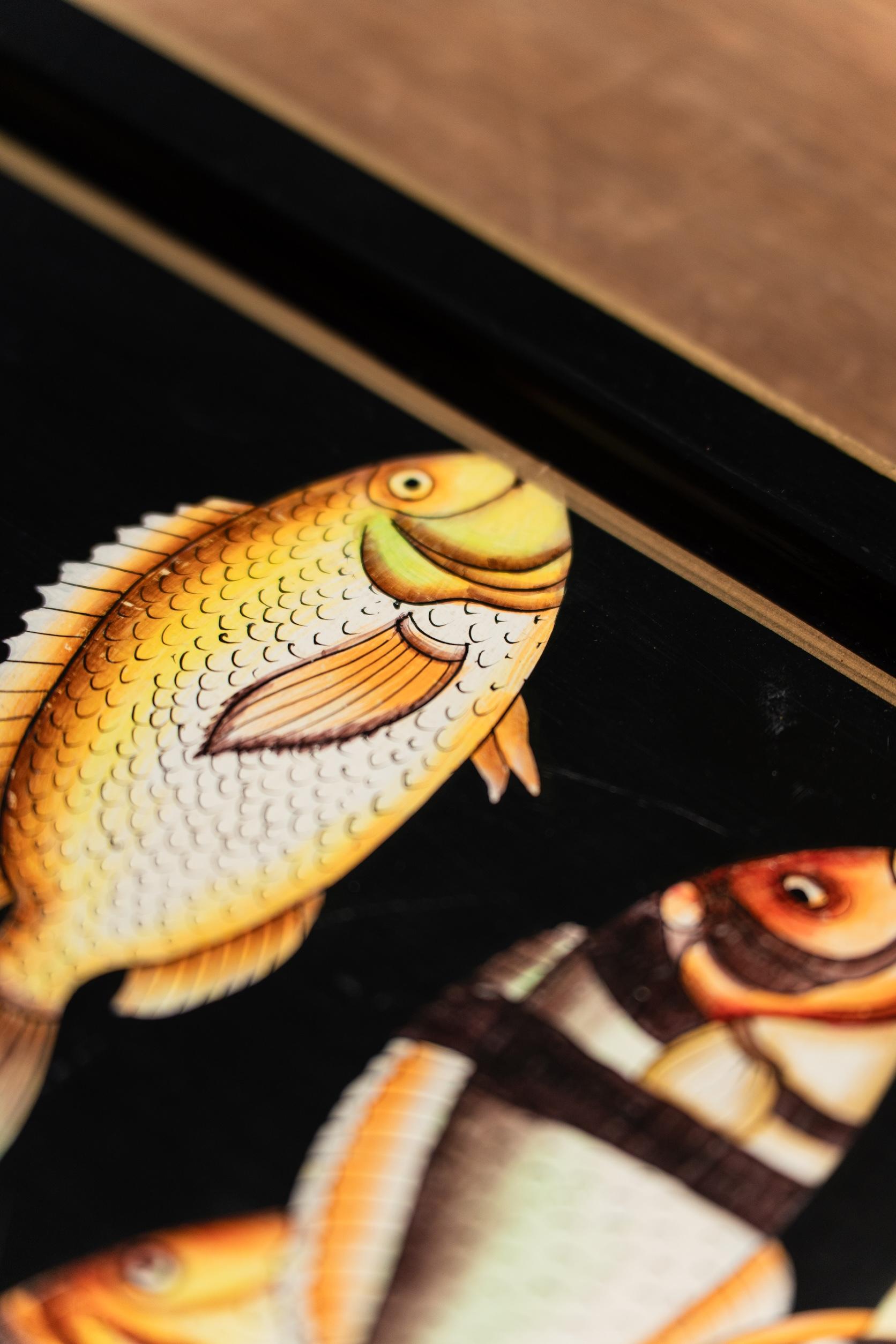 Make a bold statement with our hand-painted iron decorative tray, featuring fish on a dark background. Perfect for display, this tray adds a touch of the beach to any space. Intended for decorative use only, it’s ideal for adding depth and character