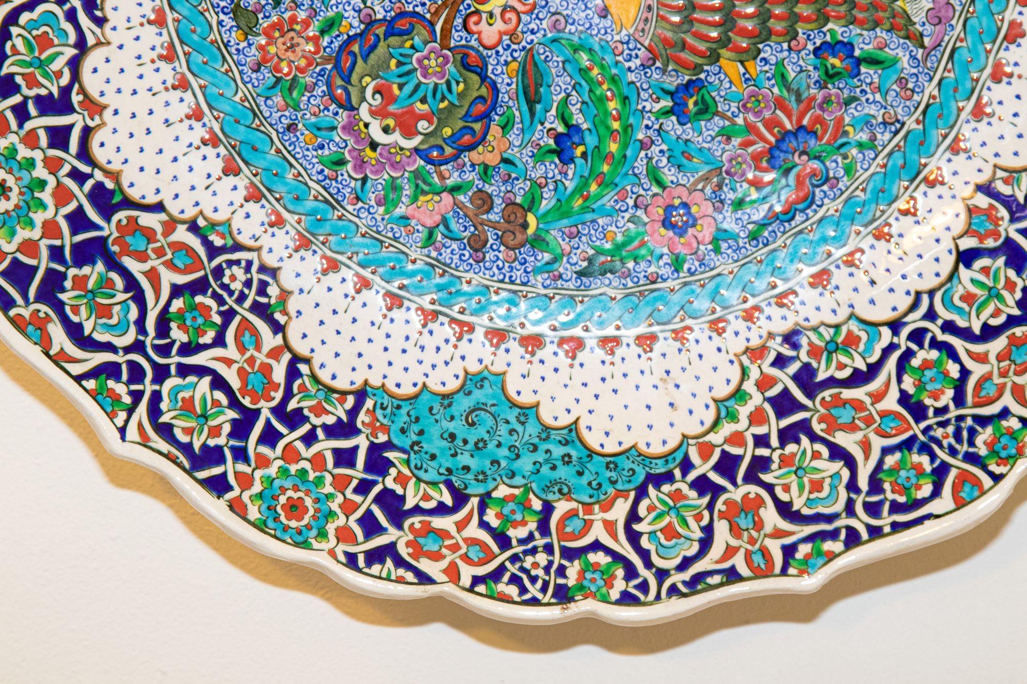Handmade decorative wall plate, hand painted by artist Saim Kolhan.
Hand Painted large Decorative wall plate after an original Iznik 16th C. Ottoman design.
This plate is hand painted with an intricate design with a peacock in the center and
