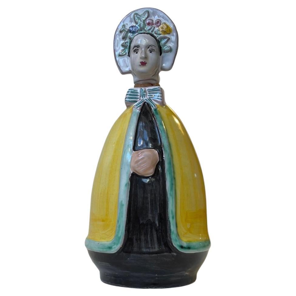 Hand-glazed ceramic/earthenware decanter depicting a woman in antique Bornholm Island Dress/costume. Studio-made at Johgus on the island of Bornholm in Denmark circa 1945-55. It can contain circa 0.5 liters of spirits/sherry/brandy/syrup etc.