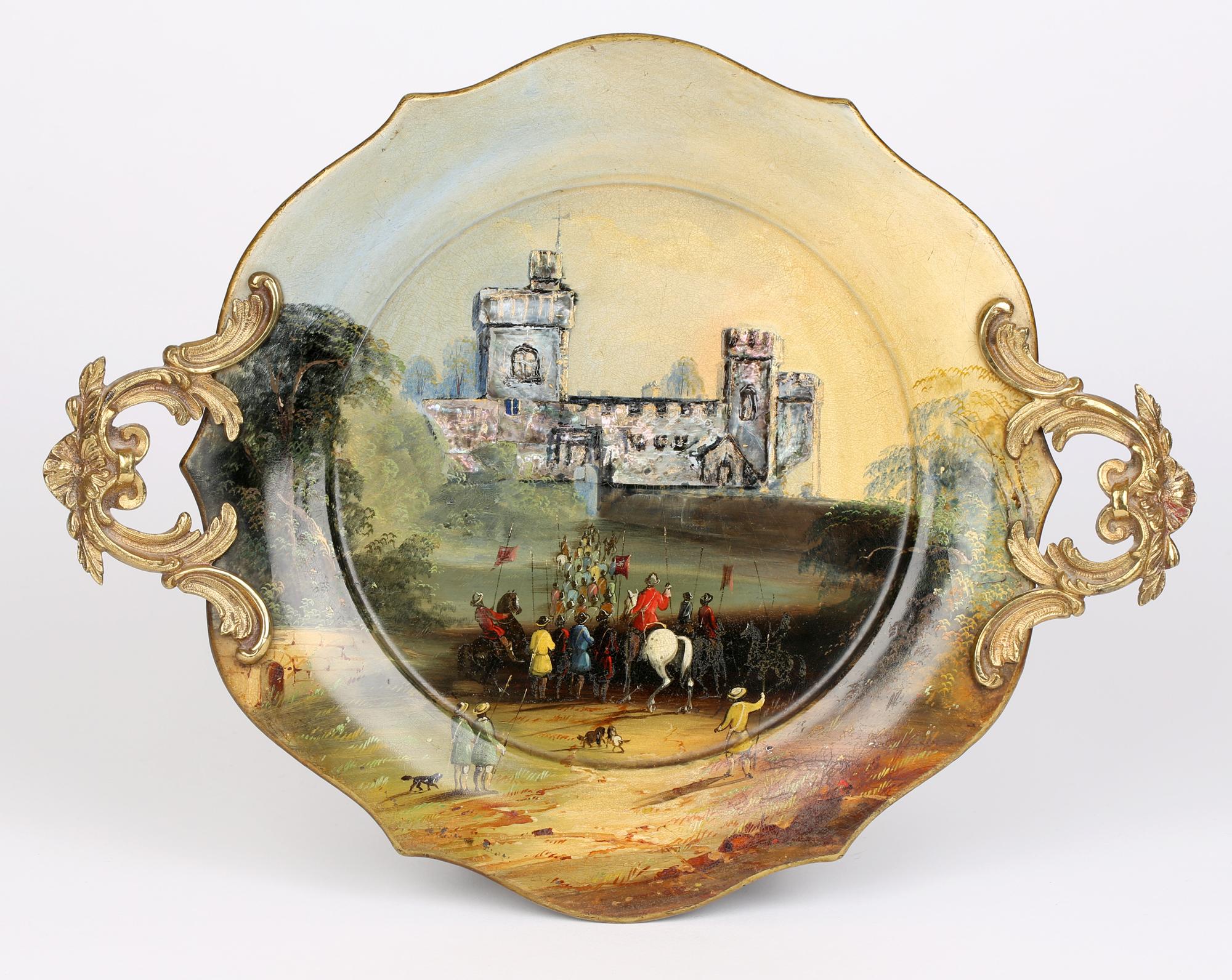 An exceptional Victorian hand painted and lacquered papier mache twin handled tray dating from around 1850. The rounded tray has a shaped rim with ornate brass rococo handles applied to either side. The tray is hand painted with castle in a