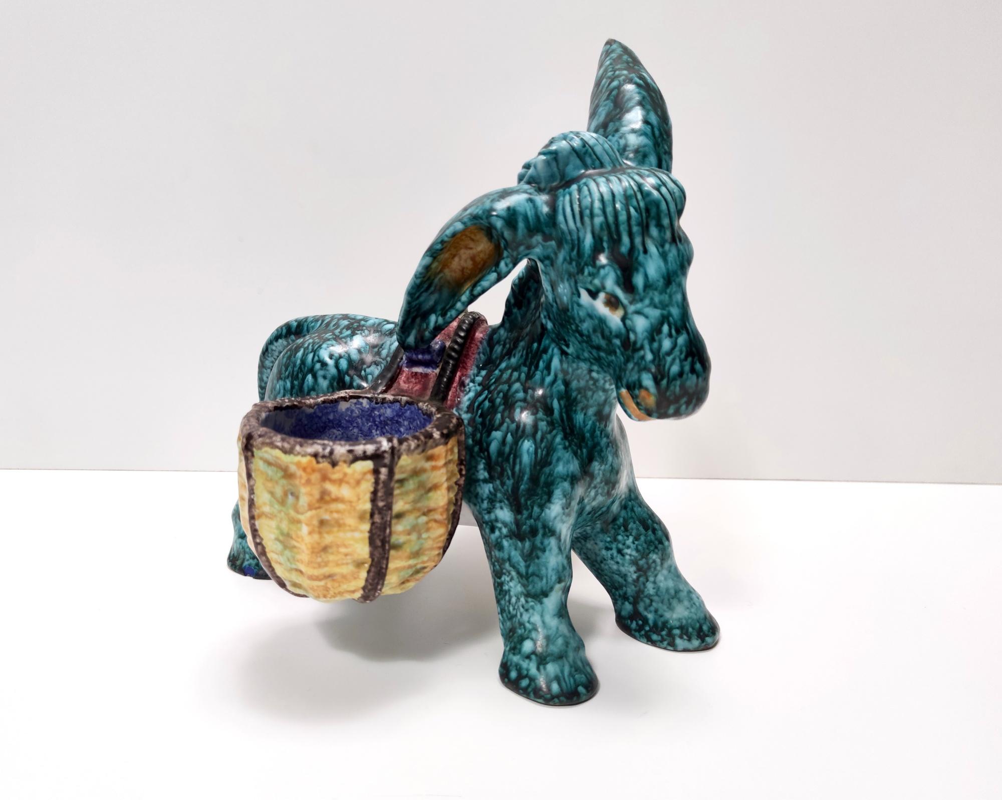 Deruta (Perugia), Italy 1983.
This is a hand-painted earthenware donkey that can be used as a table salt cellar or just as a decorative object. 
It is a vintage piece, therefore it might show slight traces of use, but it can be considered as in