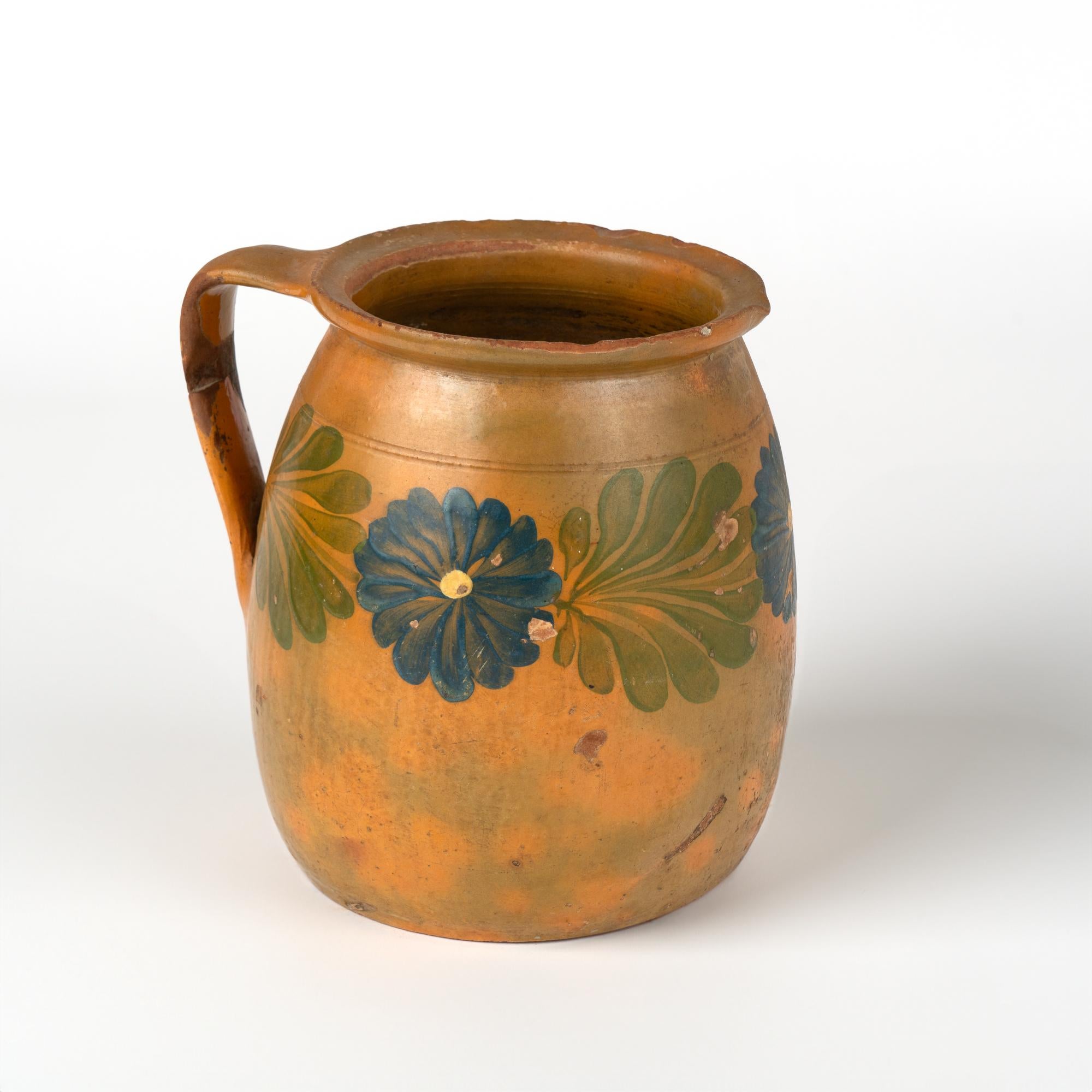 Original hand painted earthenware pottery with handle. Terracotta background with touches of green overlay, floral and leaf/vine pattern.
Sold in original vintage used condition. Any chips (especially along rim), cracks(see old repair to handle),